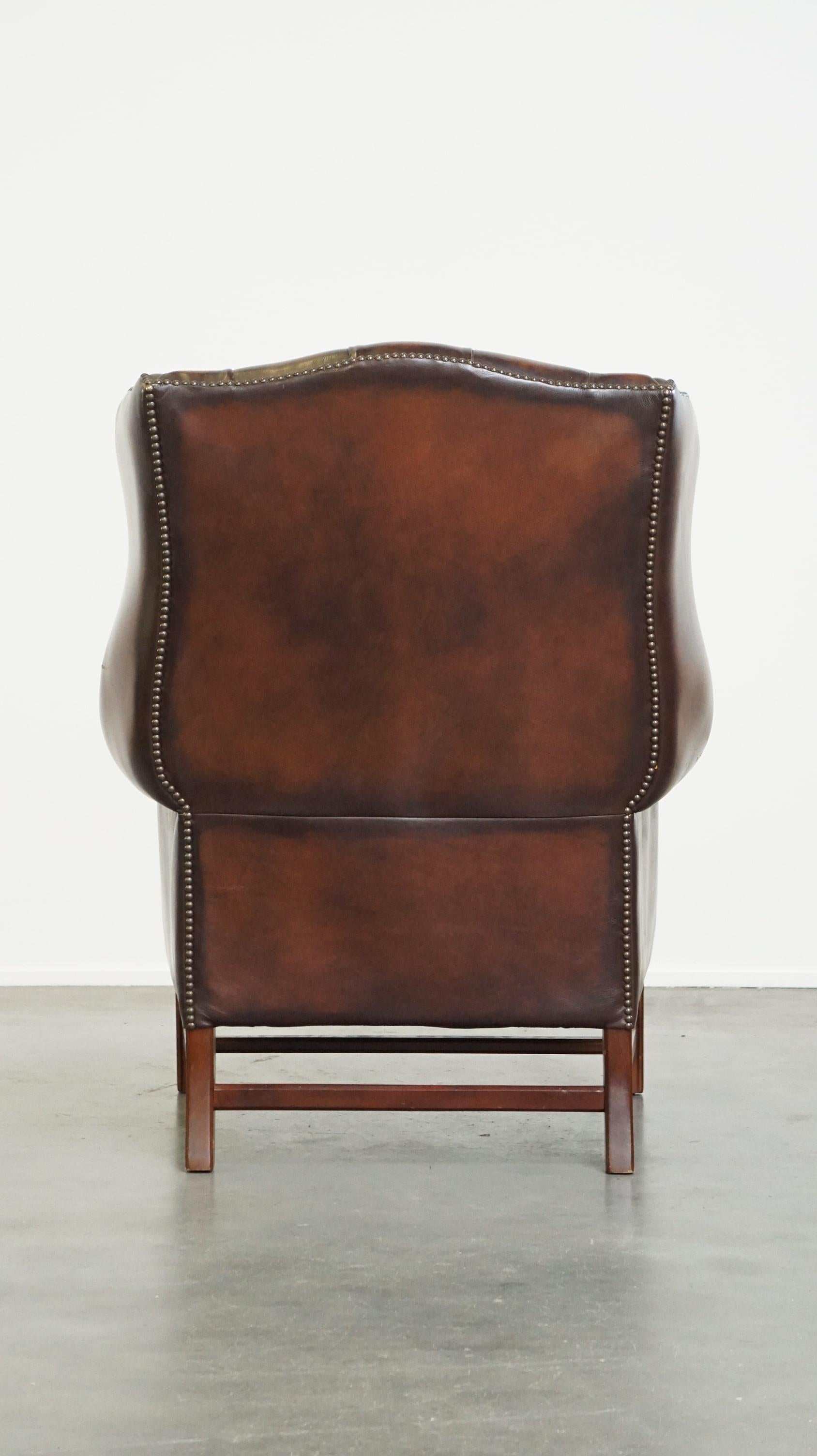 English Luxurious brown leather chesterfield armchair finished with decorative nails For Sale