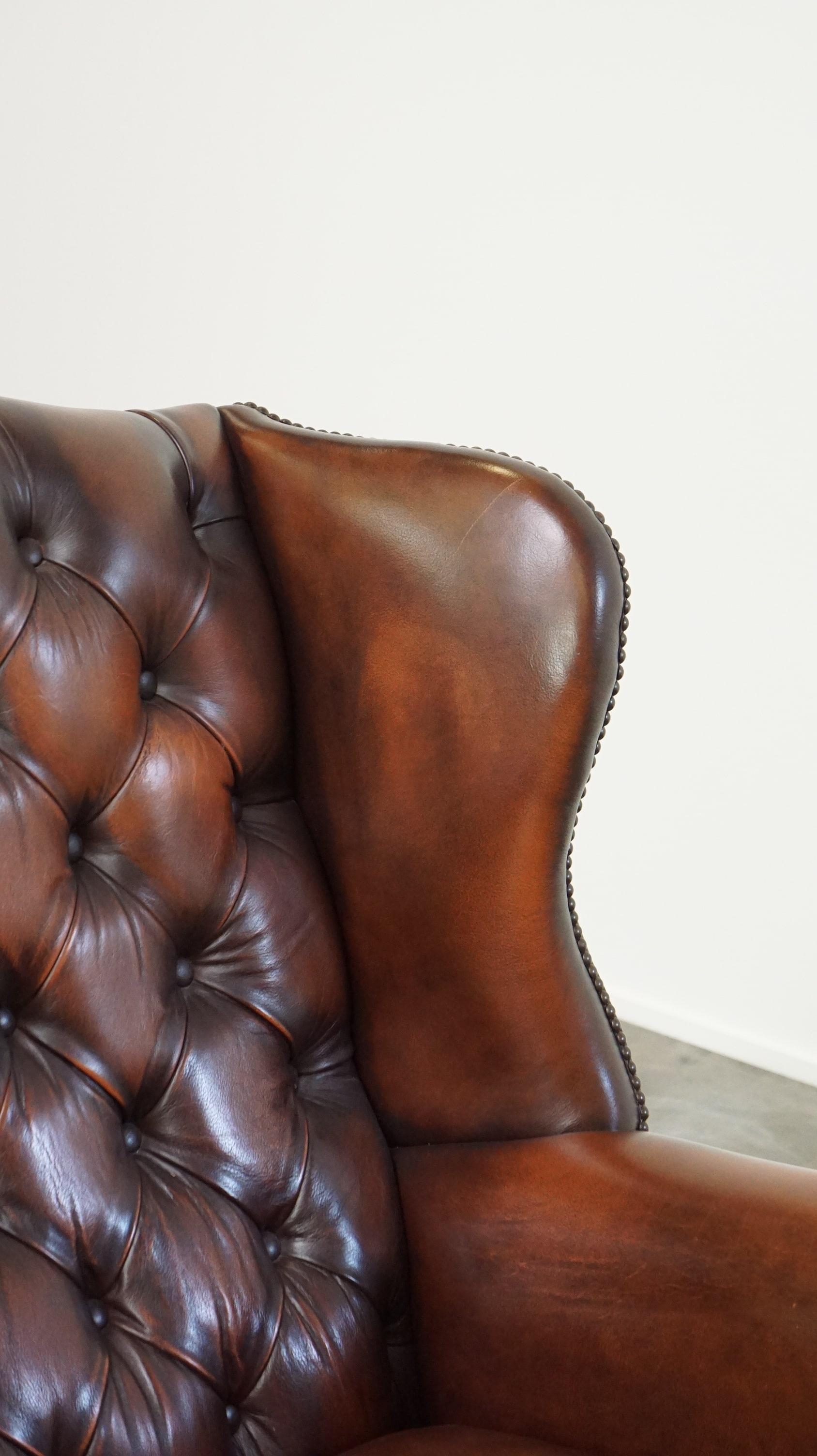 Luxurious brown leather chesterfield armchair finished with decorative nails For Sale 1
