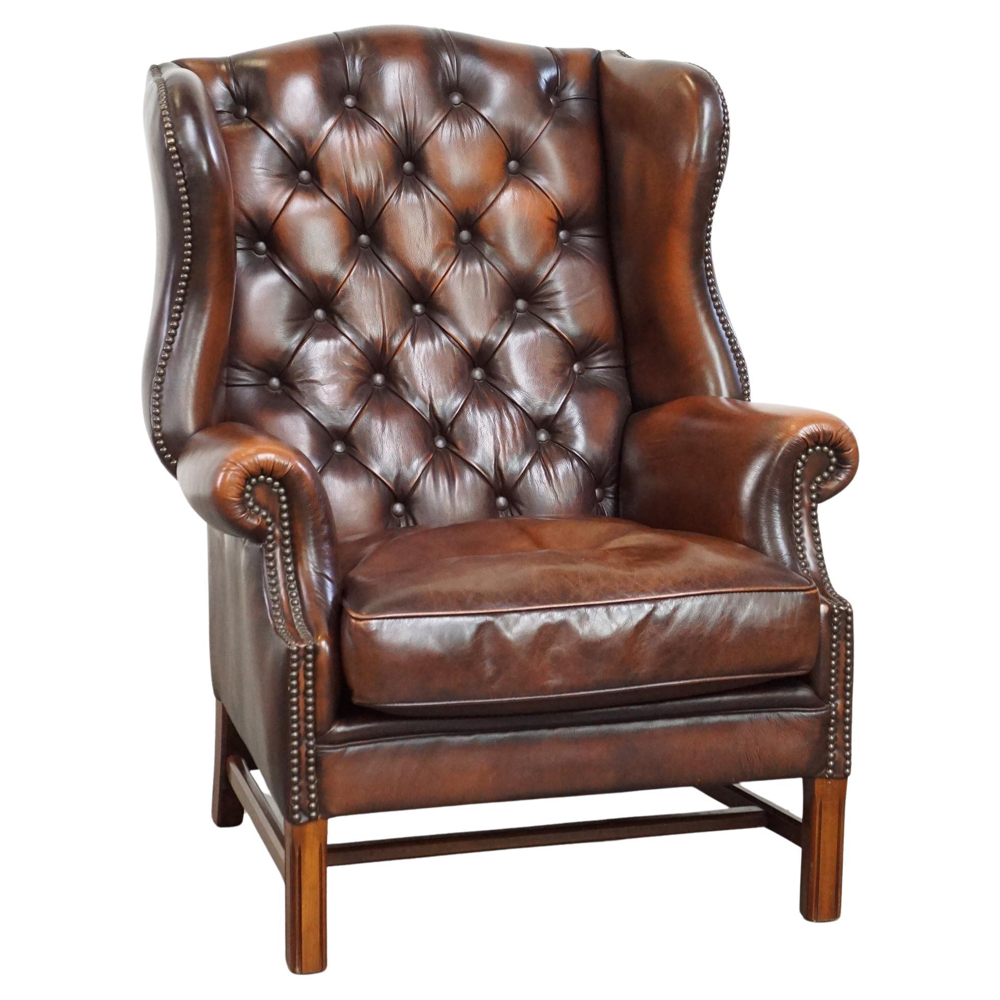 Luxurious brown leather chesterfield armchair finished with decorative nails For Sale