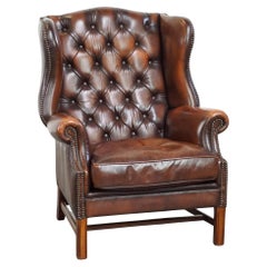 Luxurious brown leather chesterfield armchair finished with decorative nails