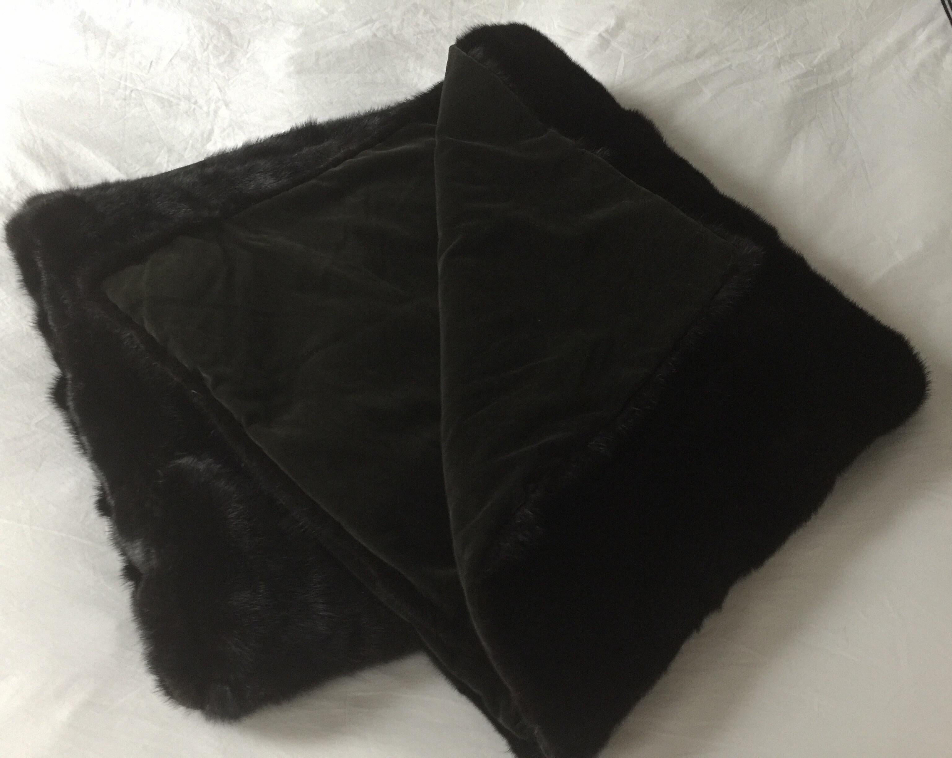 A custom mink fur throw blanket. Lined in olive green cotton velvet. Dark brown. Made in USA, circa 2010.
Measures: 84 inches x 48 inches.