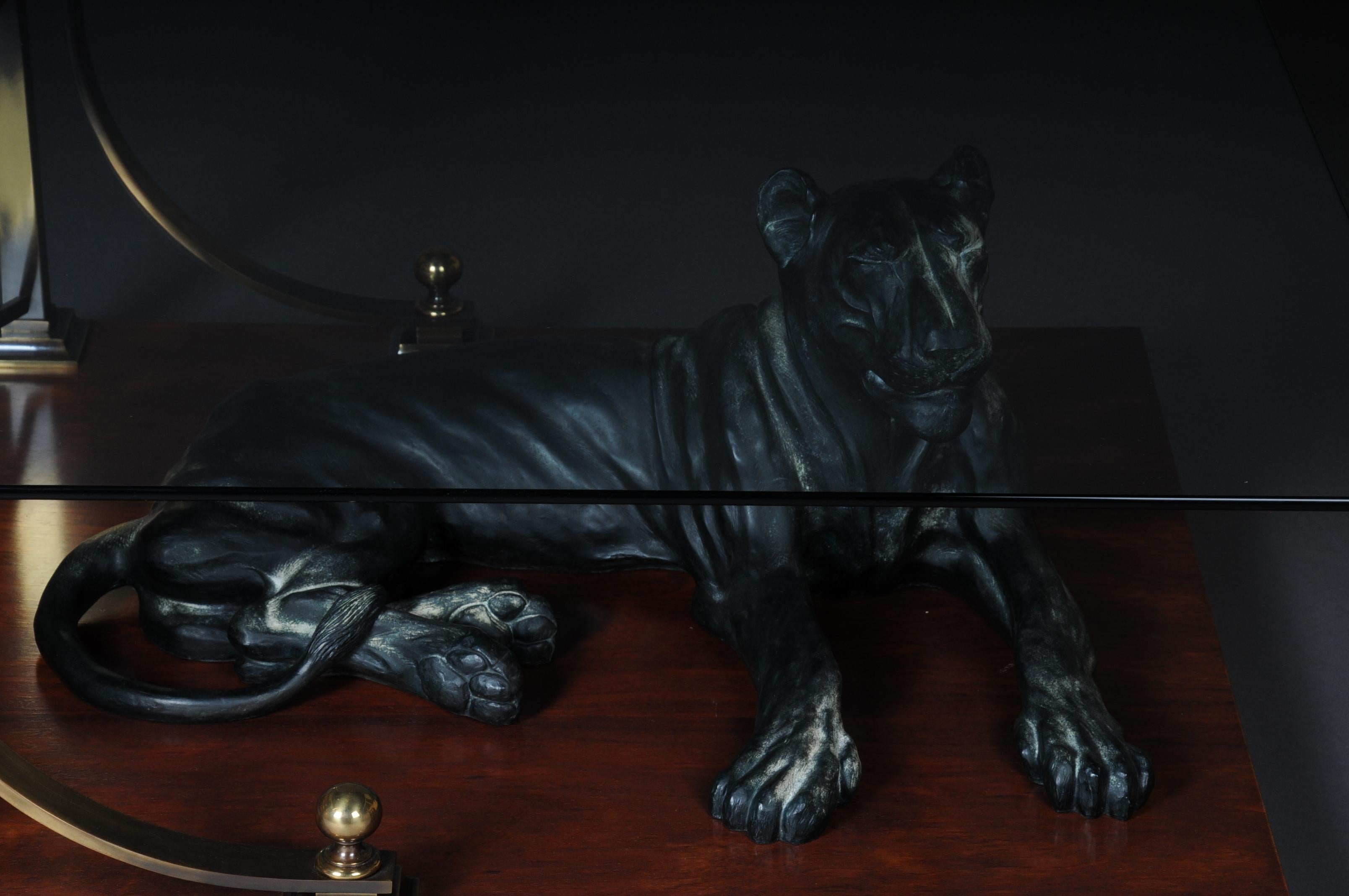 Extremely high quality designer coffee table. Sitting in the middle of the floor plate a life-size cat or panther. Faceted glass top connected with solid brass frame.
Tabletop made of solid wood.
Very decorative and an absolute highlight in every