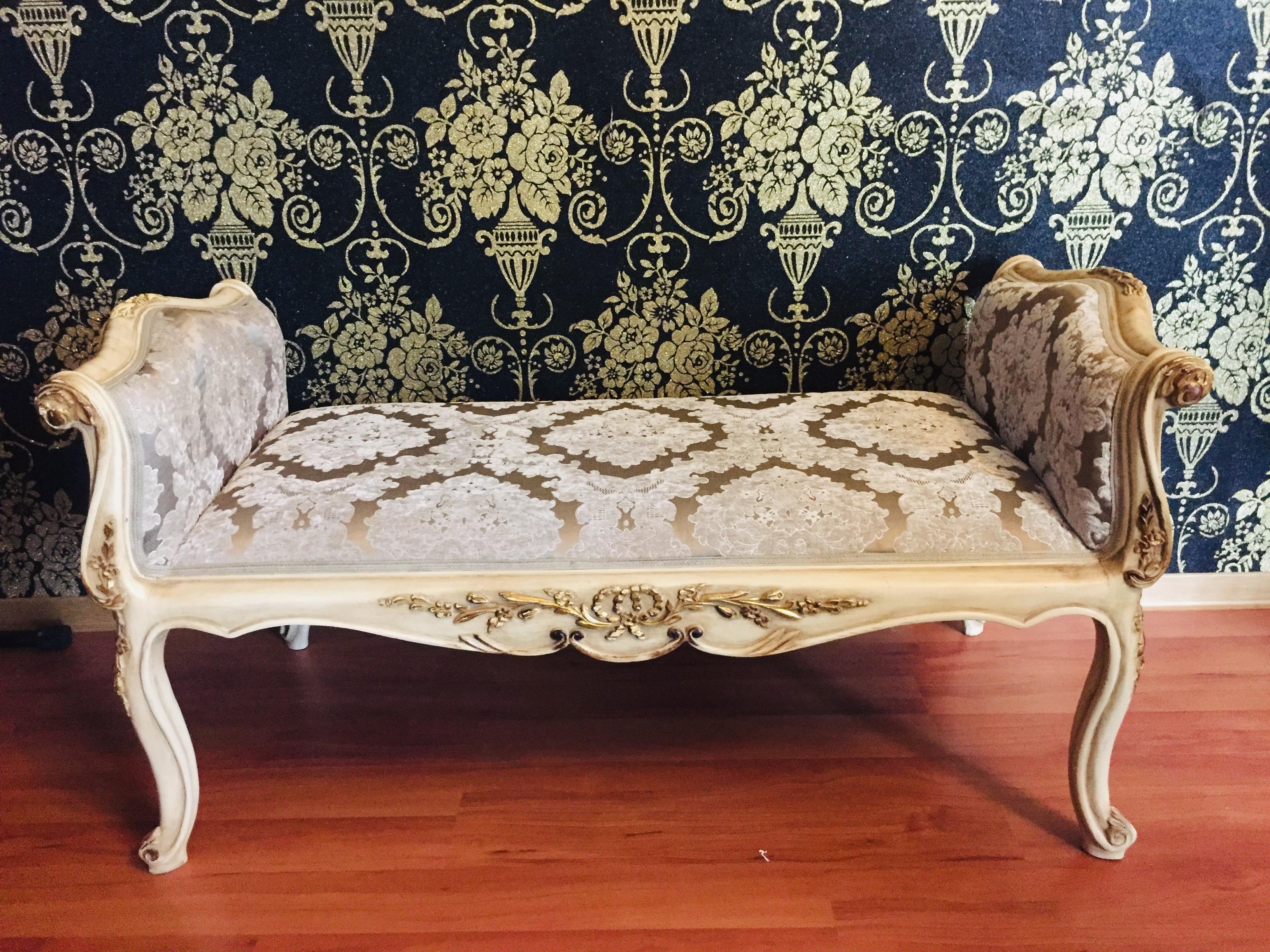Solid beechwood, gilded with gold-plated trim, snug curly frame on four curved legs. The seat is finished with a historical, classic upholstery.