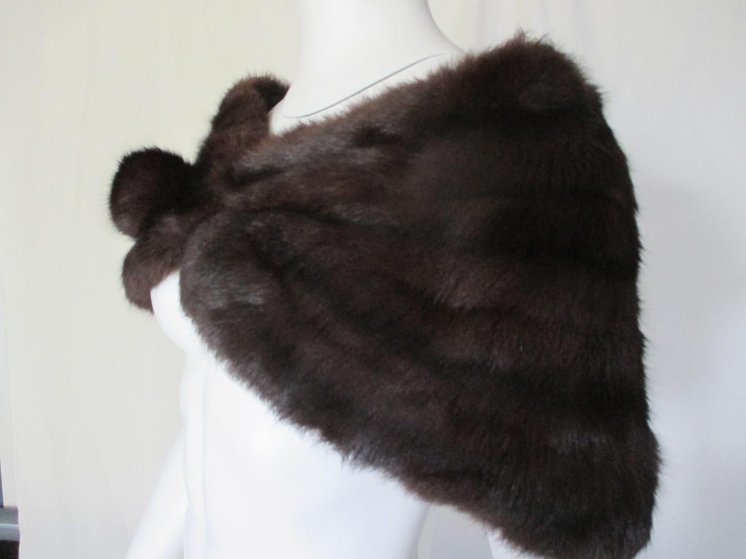 This vintage beautiful stole is made of very soft dark brown fur and is light to wear, with brown lining, 2 press buttons closures and at front a decorative fur button.

We offer more luxury fur, view our storefront.

Details:
Furrier: Goodfriends,