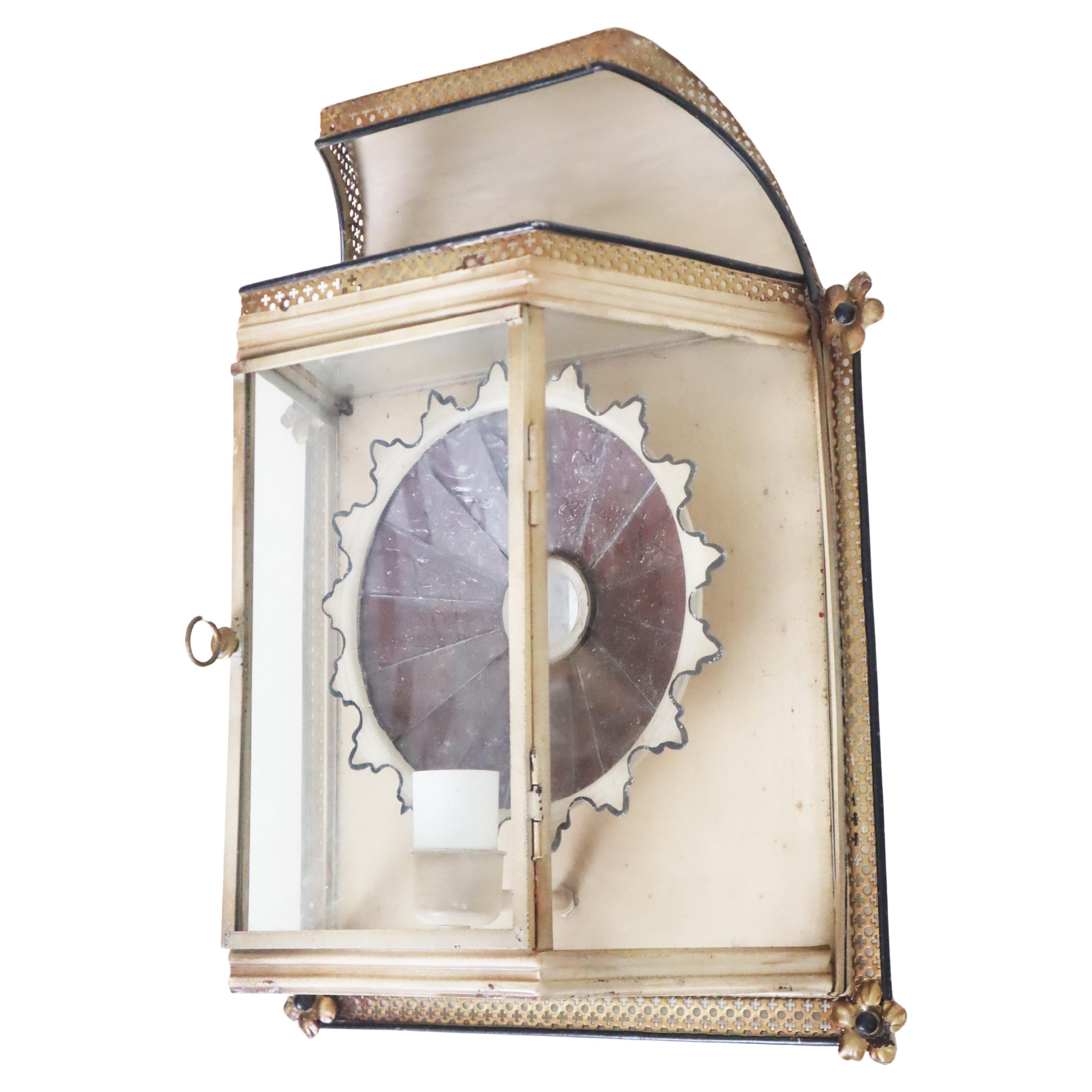 This exclusive wall lantern from the 1960s features a magic mirror that magically reflects the light from the bulb, enchanting the room with this beautiful light. The lamp originates from an old villa and hung on the wall there for many decades,