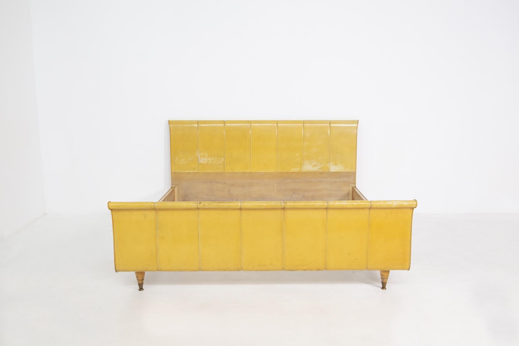 Luxurious and elegant Italian parchment and wood bed from the 1950s.
The bed is made of yellow parchment for the two headboards.
The headboards of the bed, both the front and the back, have inlets that create a soft play of volumes, almost recalling
