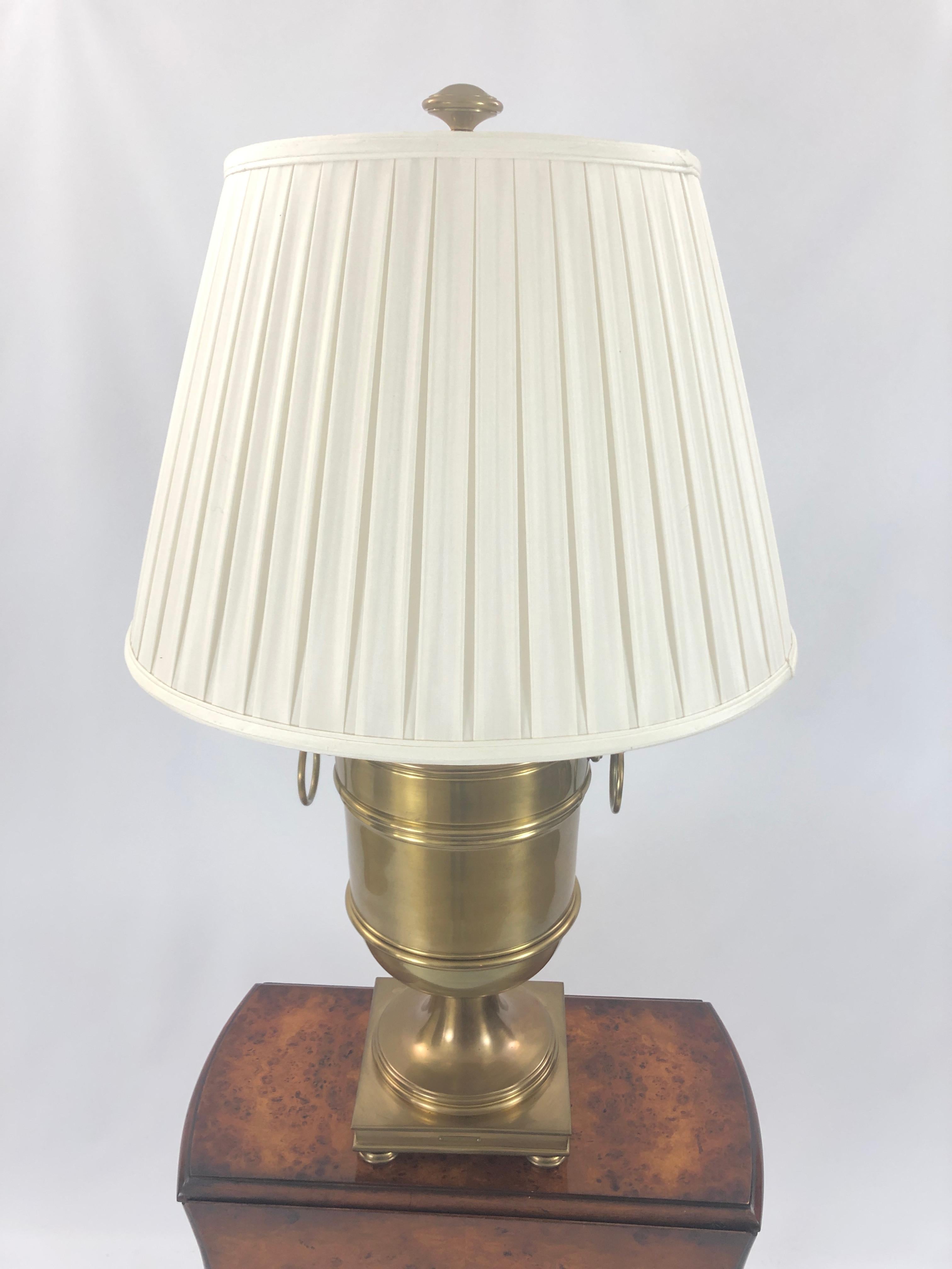 Fabulous impressively sized brass urn lamp with decorative rings on the sides and square bases on feet, beautifully made by Ralph Lauren with label on the front.
Custom pleated shade and handsome meaty finial on top.
Measures: Urn is 11 w 35 H 9