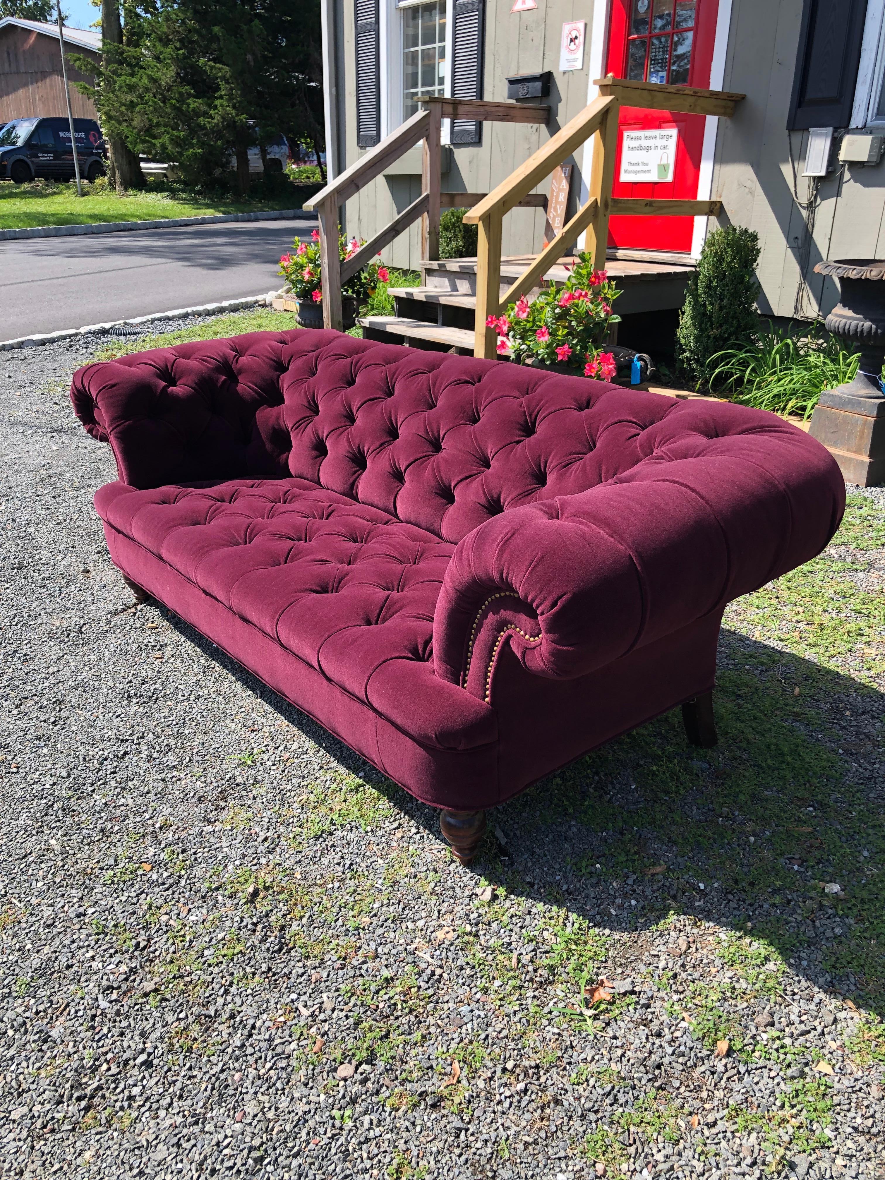 An iconic symbol of traditional British design and craftsmaship, the tufted Chesterfield sofa as sumptuously upholstered in new plum purple mohair and finished with brass nailheads.
seat depth 22