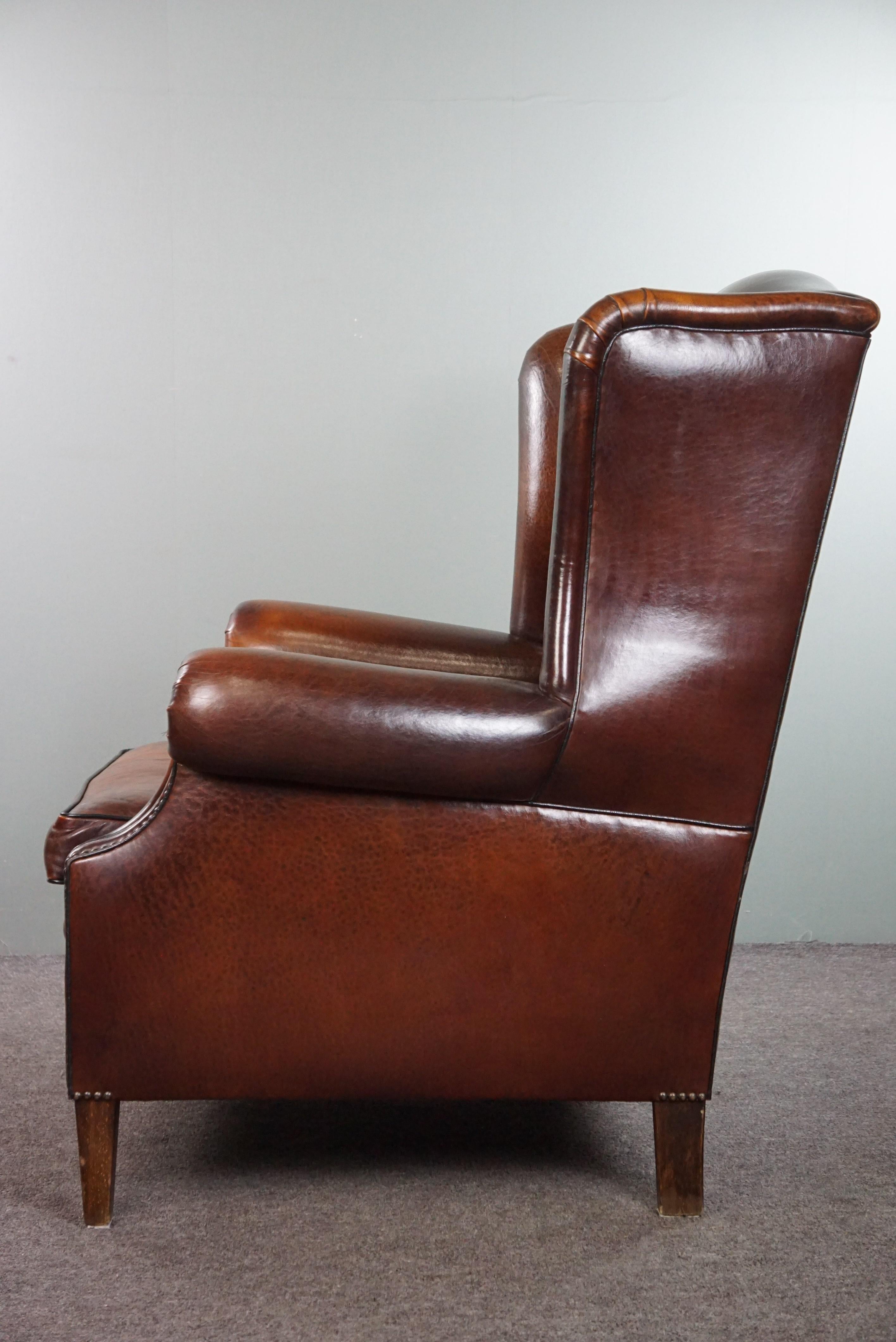 Leather Luxurious large sheep leather wingback armchair with beautiful colors and patina For Sale