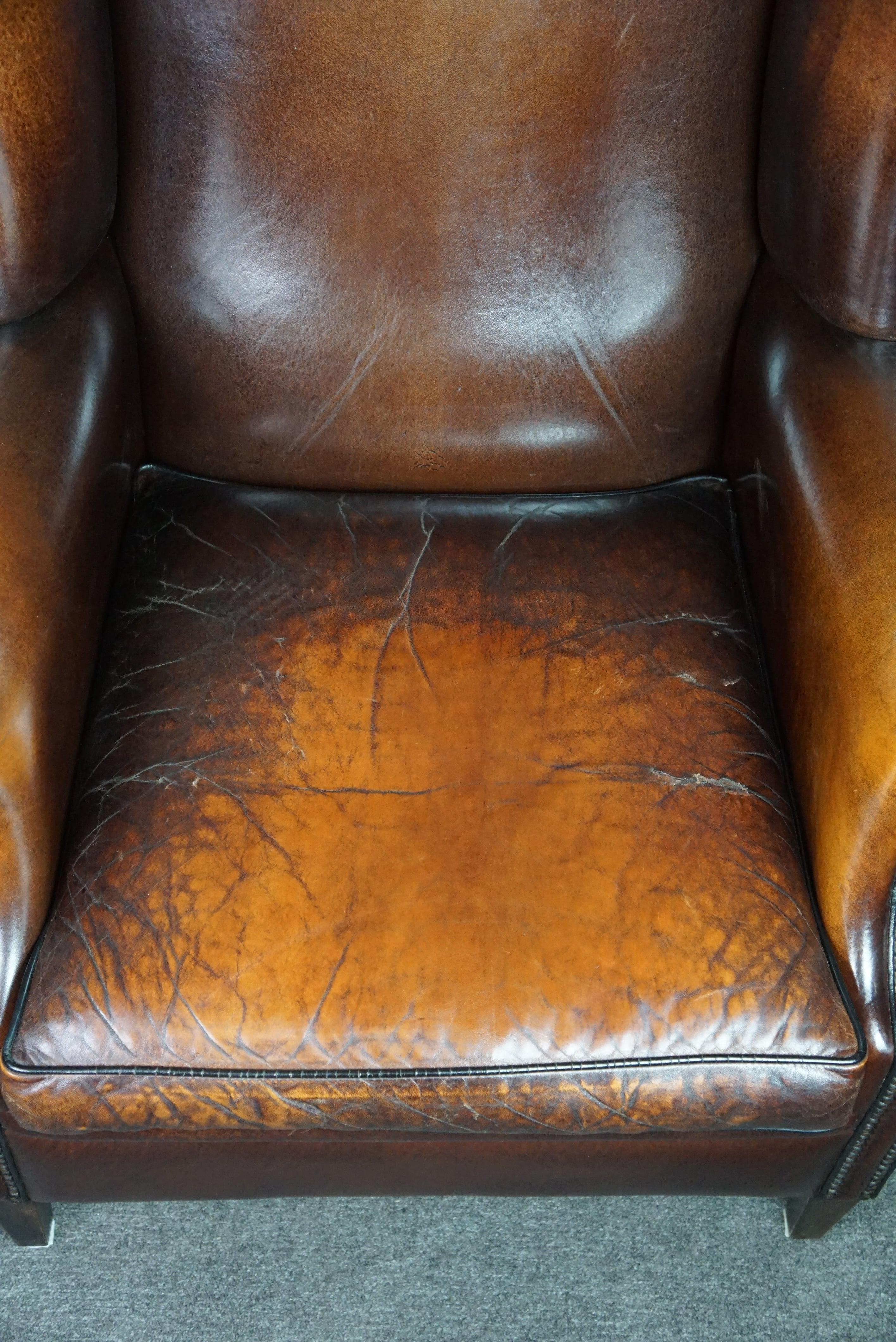 Luxurious large sheep leather wingback armchair with beautiful colors and patina For Sale 1