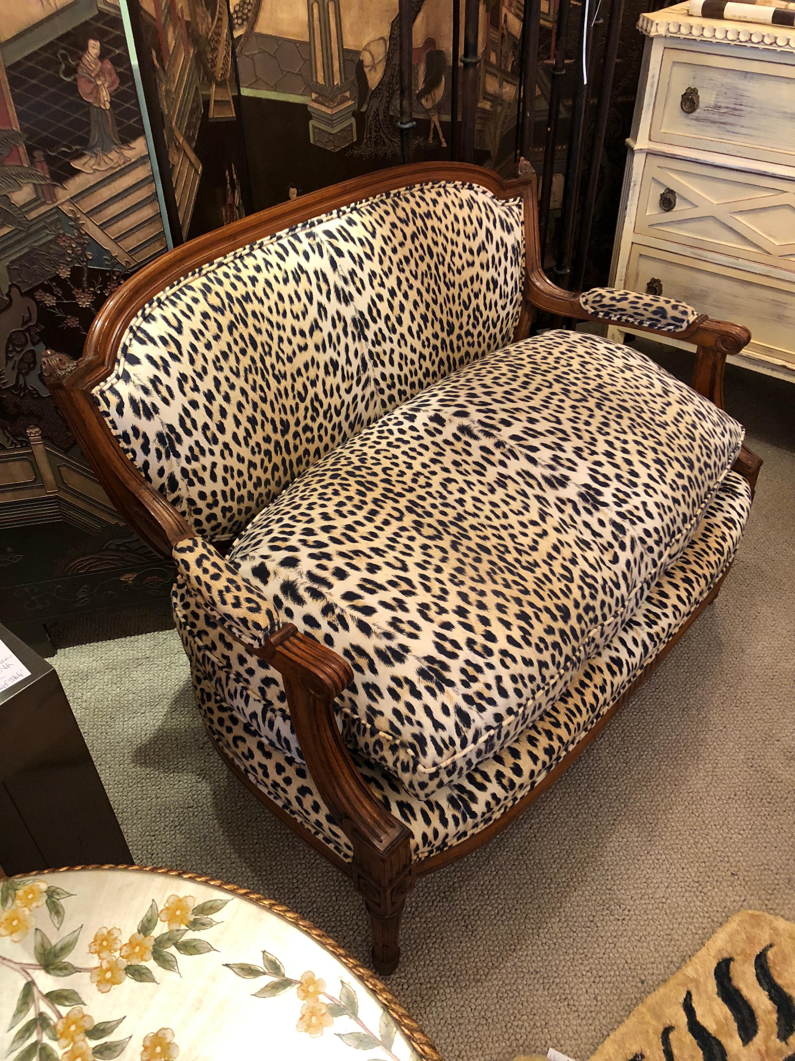 A special very sexy little loveseat having a beautiful French carved walnut frame and sumptuous Boussac faux animal print upholstery. Seat cushion is down filled and beckoning.