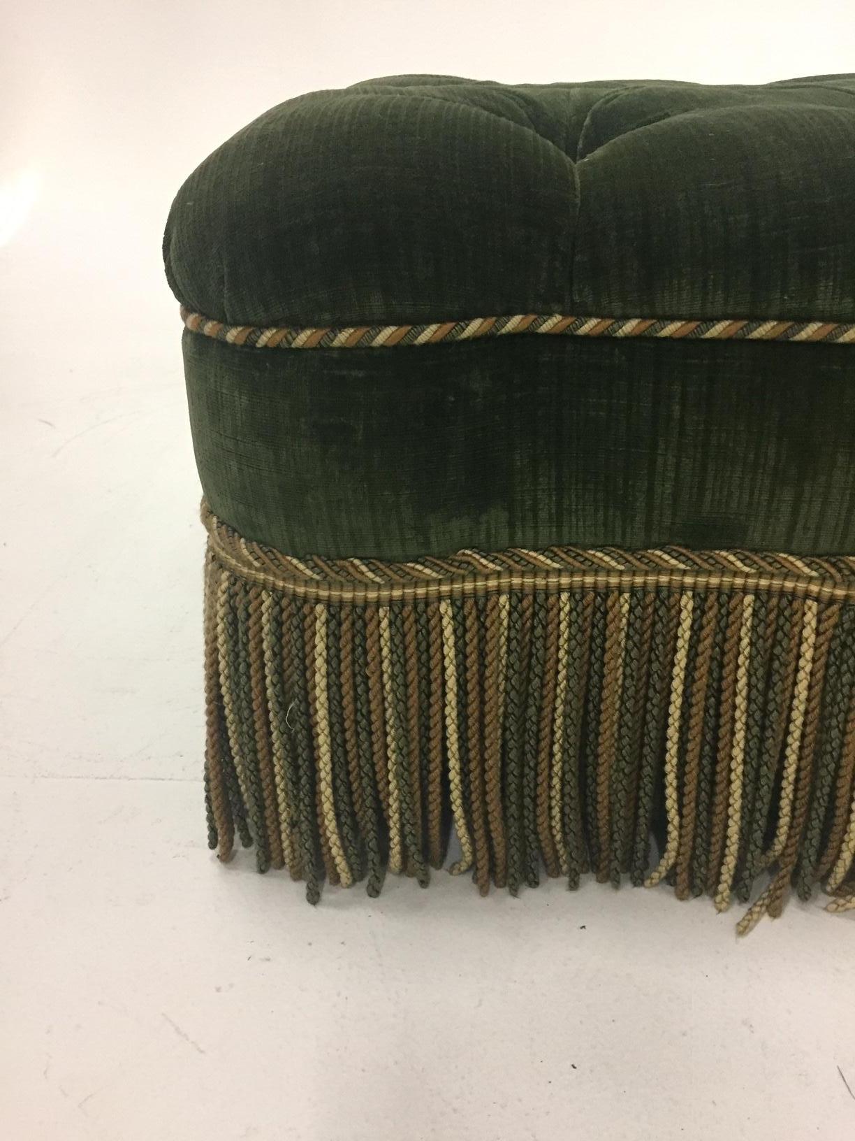A rich dark green velvet designer custom made tufted ottoman with dramatic buillion fringe. Great used as a coffee table with tray on top.