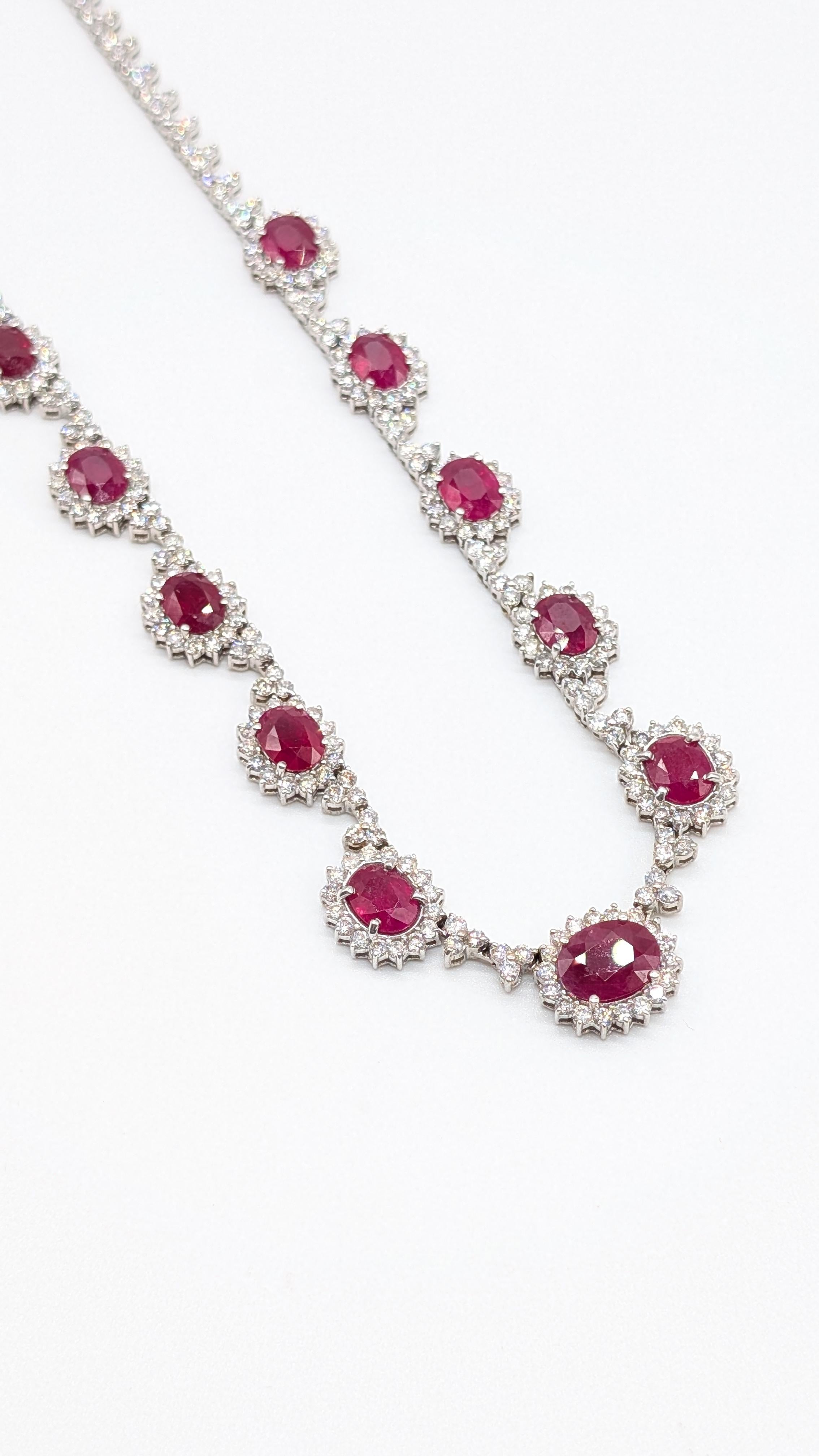 Spectacular 14K White Gold Necklace with 18.65 Carats of Oval-Cut Rubies and 12.00 Carats of Round Diamonds

A masterpiece of timeless elegance, this exquisite necklace showcases a stunning array of vivid oval-cut rubies totaling approximately 18.65