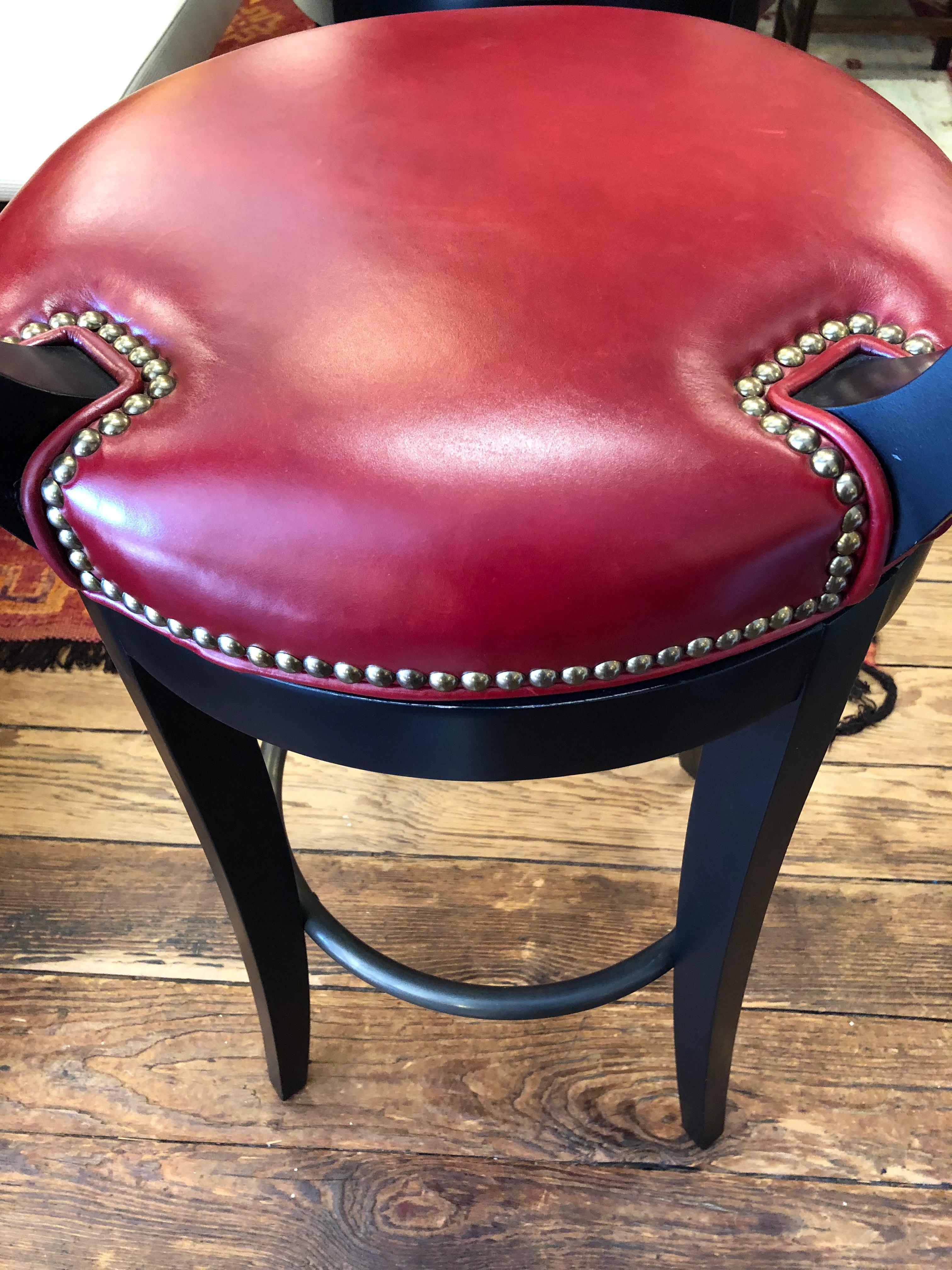 Super luxurious solid and comfortable set of 4 Vanguard Miles bar stools that are part of the Compendium Collection.  Wood is ebonized black and the seats are a plush red leather.  The foot rest is rubbed bronze finish on brass.  These were custom