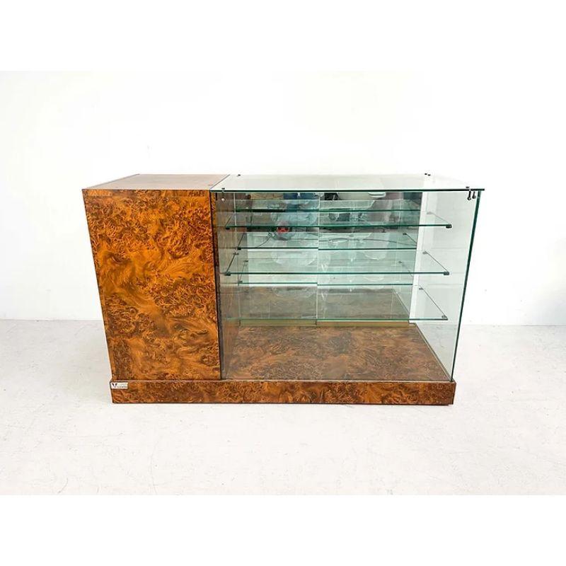 Luxurious Shop Counter in Burl Wood with Brass Accents

High-end store counter of Italian manufacture. The luxurious store counter in a perfect example of good craftsmanship. It was probably made in the 1980s in Italy. The furniture is made of