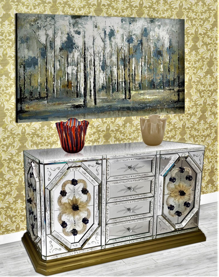 Luxurious sideboard in mirror engraved and beveled entirely by hand by Fratelli Tosi, with gold and blue Murano glass finishes made according to the ancient Muranese traditions, composed of four central drawers and two side doors, with gilded wooden