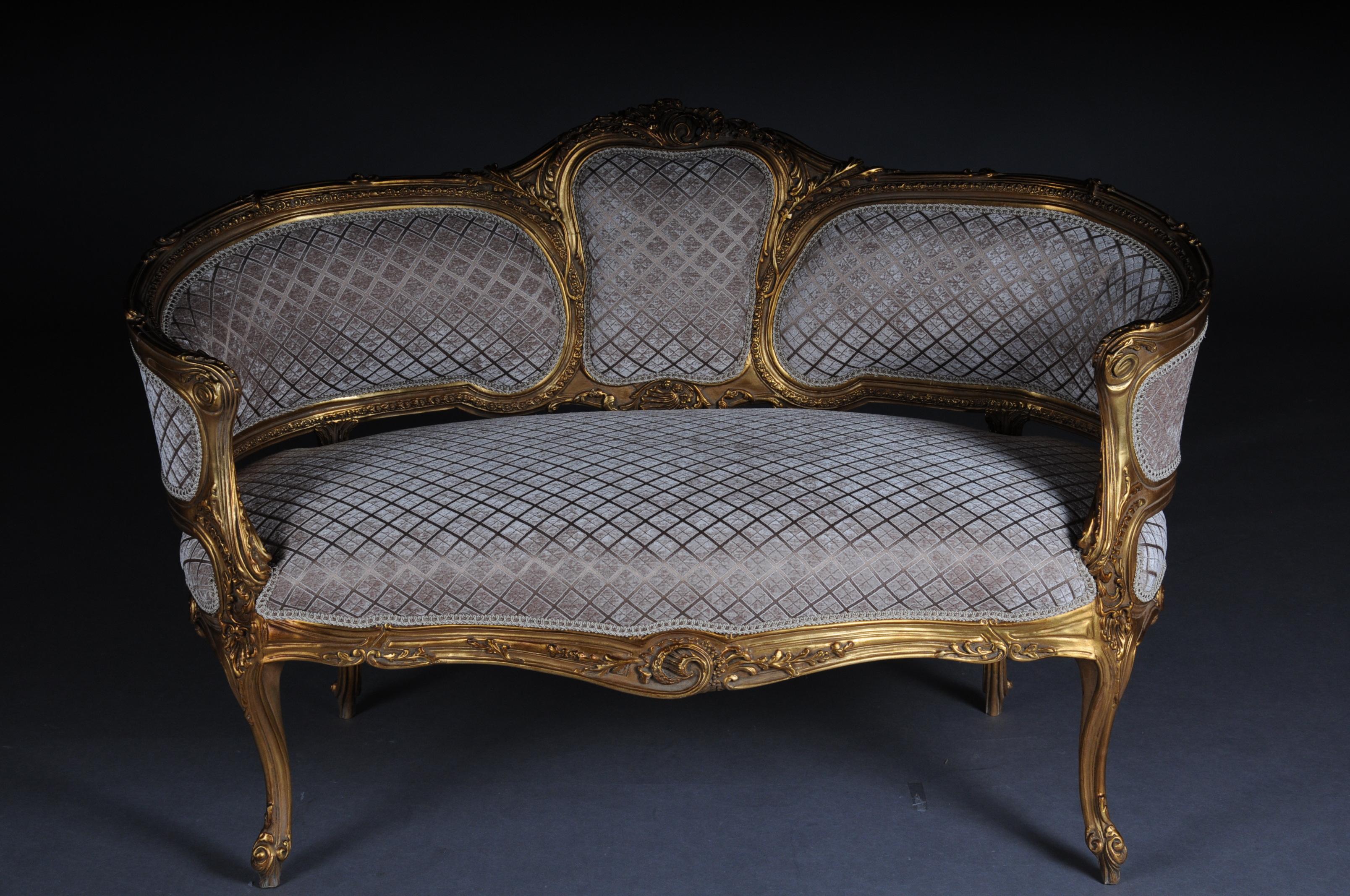 Luxurious sofa, canapé, couch in Rococo or Louis XV style.

Solid beech wood, carved and gilded. Rising backrest framing with openwork rocaille crowning. Appropriately curved frame with richly carved foliage. Slightly curved frame on straight