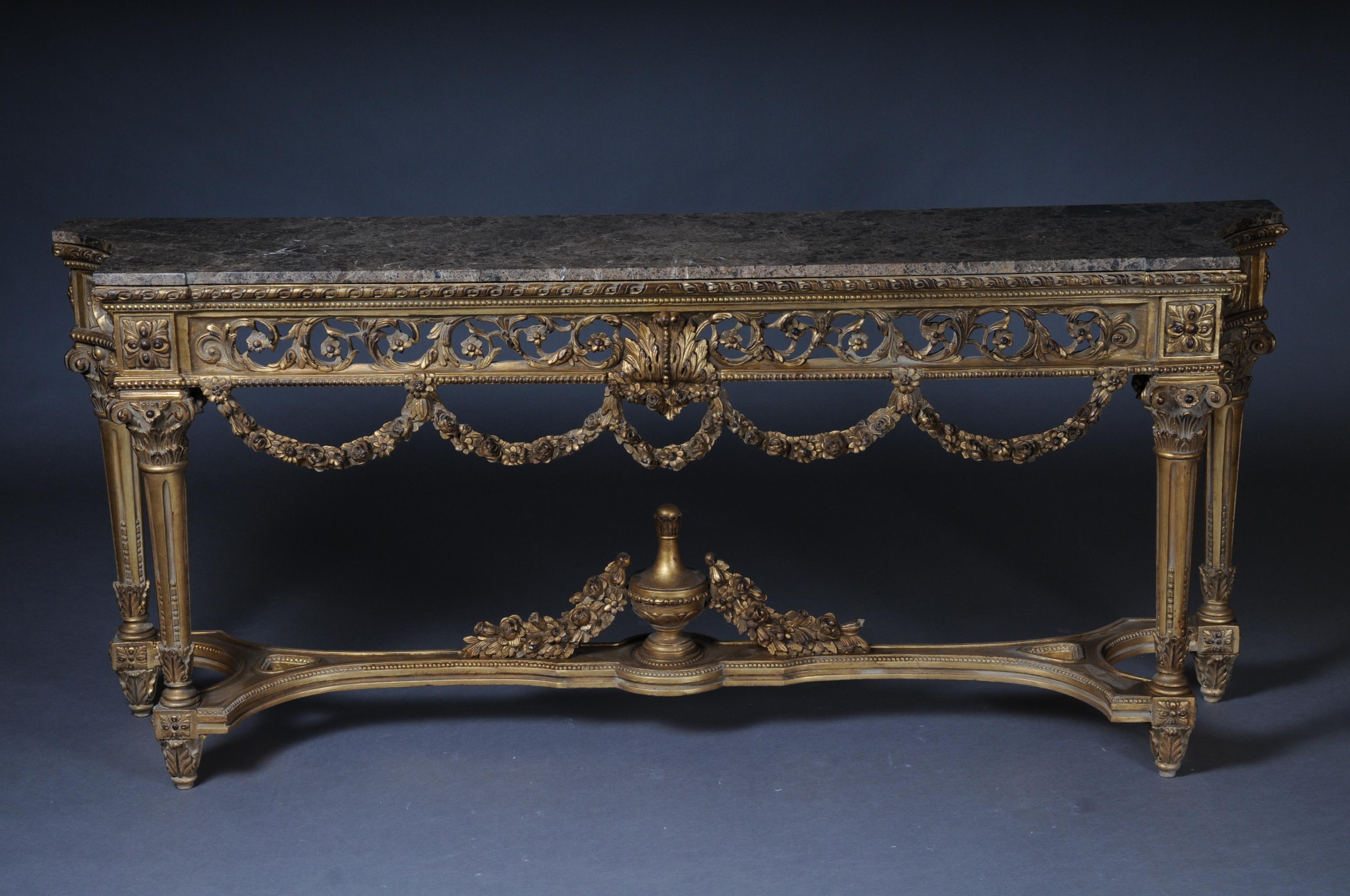 High quality solid beechwood finely carved down to the last detail. Colored and gilt gilded. On conical, carved square legs, connected with X-shaped, heavily carved gutter. With garlands pierced ornamental frame pedestal. Protruding, profiled,