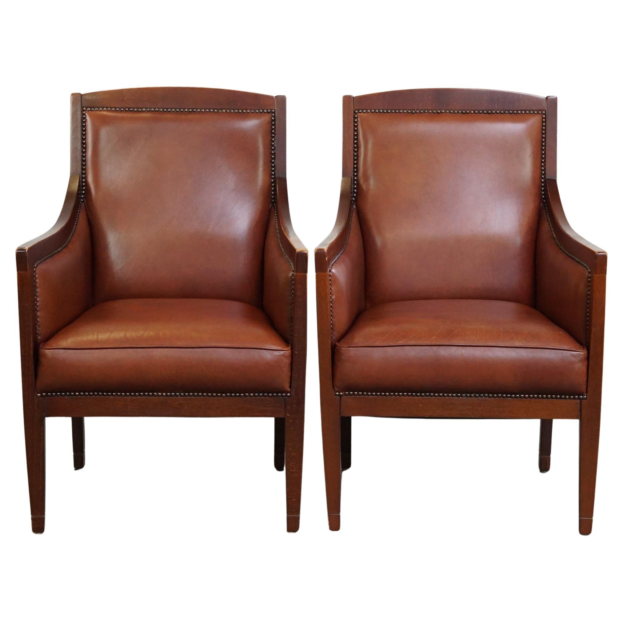 Lussuoso, maestoso, set di 2 poltrone in pelle di mucca color cognac dal design Art Deco
