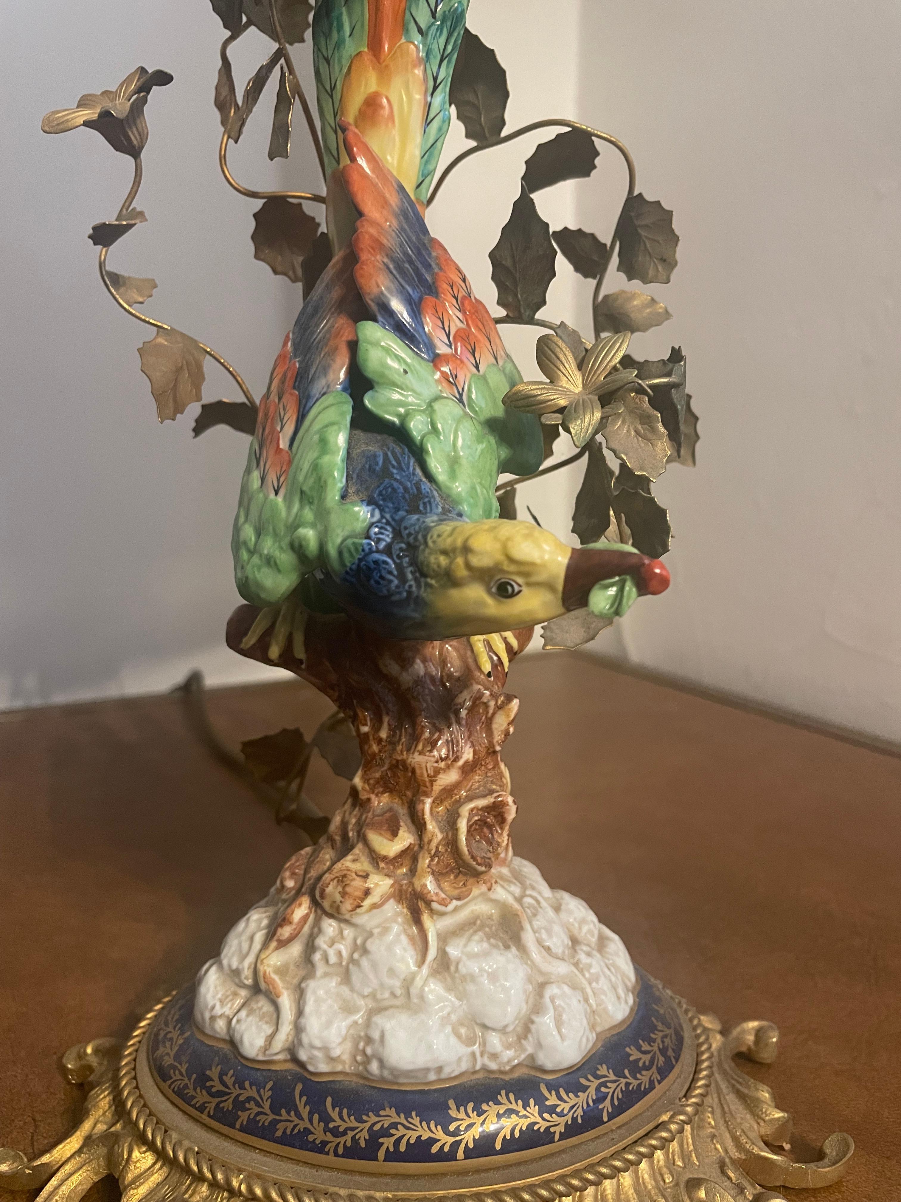 Italian table lamp in porcelain with exotic bird and  flowers mounted on a gilt base, Sèvres style porcelain - With flowers.
1950s
 comes with its original Silk shade.
Two small l SES bulbs needed .
* The shade has a water stain , please see pictures
