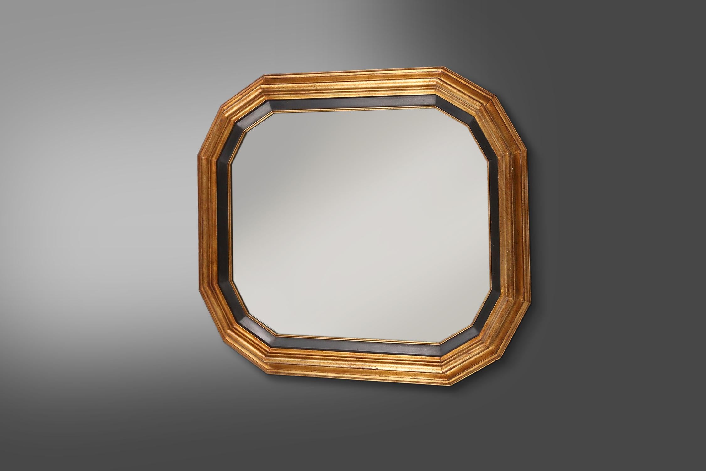 Belgium / 1950s / gold and black mirror / resin / mid-century / vintage

A large mirror with gold and black frame in elegant lines, Belgium, made in the 1950s. Crafted in resin, this mirror exudes luxury and elegance. The gold frame adds a touch of