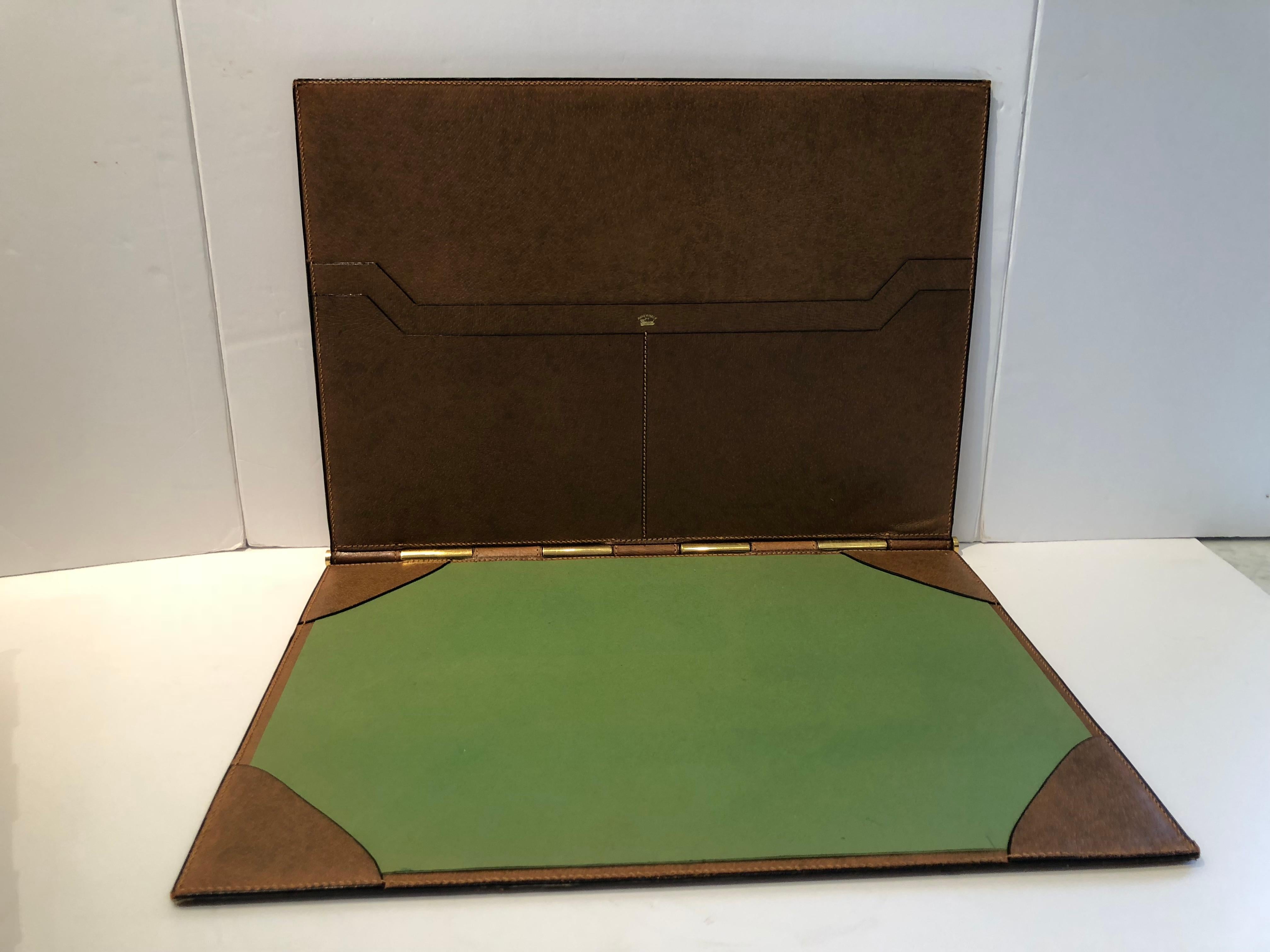 Top of the line designer desk set having a blotter with pockets, an ink blotter, a mail holder and a tray to hold paperwork. All are in matching camel leather with solid brass hardware. Each piece has the Gucci logo except the blotter. Measurements