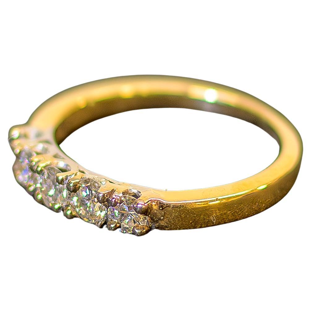 This 14k Yellow Gold Diamond Band Ring is a classic and elegant piece, perfect for any jewelry collection. It features five brilliant round diamonds, each securely set in 4 prongs to showcase their sparkle and brilliance. With a total diamond weight