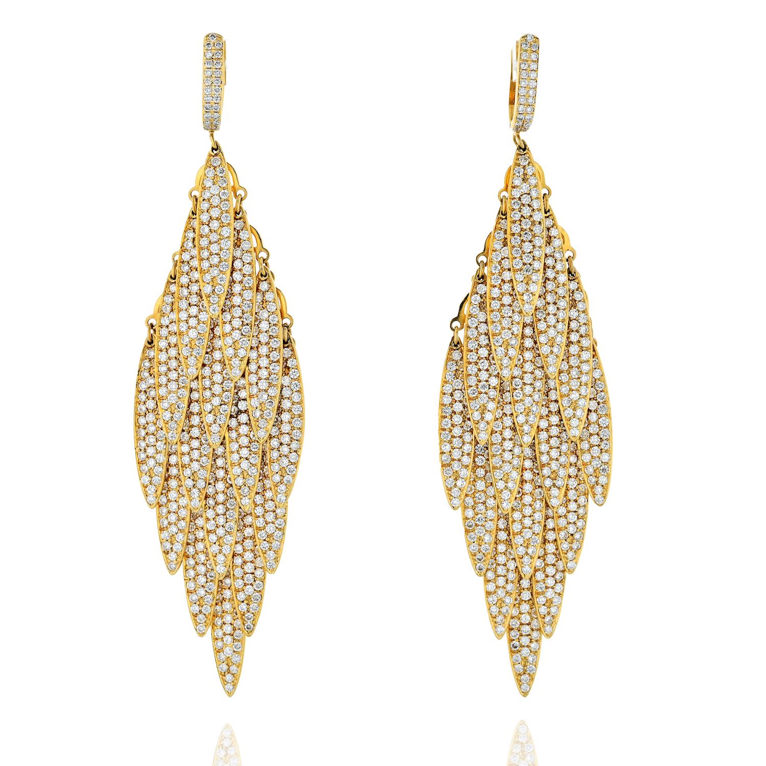 These large pendant luxury diamond drop earrings are crafted in 18K yellow gold mounted with 15 carats of round cut diamonds. There are 16 dangling plates that comprise a wonderful soft shaking earring. Each earring is finished by a post with a