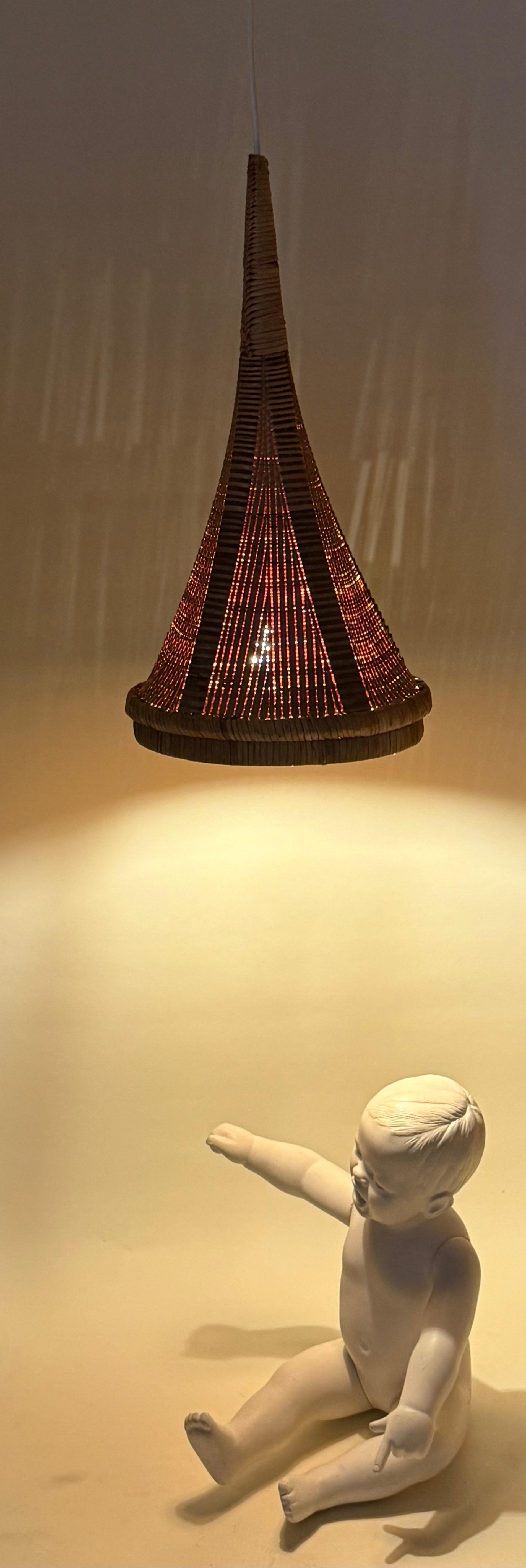 This lamp is a unique one. It originally belonged to an art collector who had it made in the 1960s. The lampshade is the real showstopper! It's a beautiful basket made in cameroon around 1850. It was passionately transformed into this unique lamp in