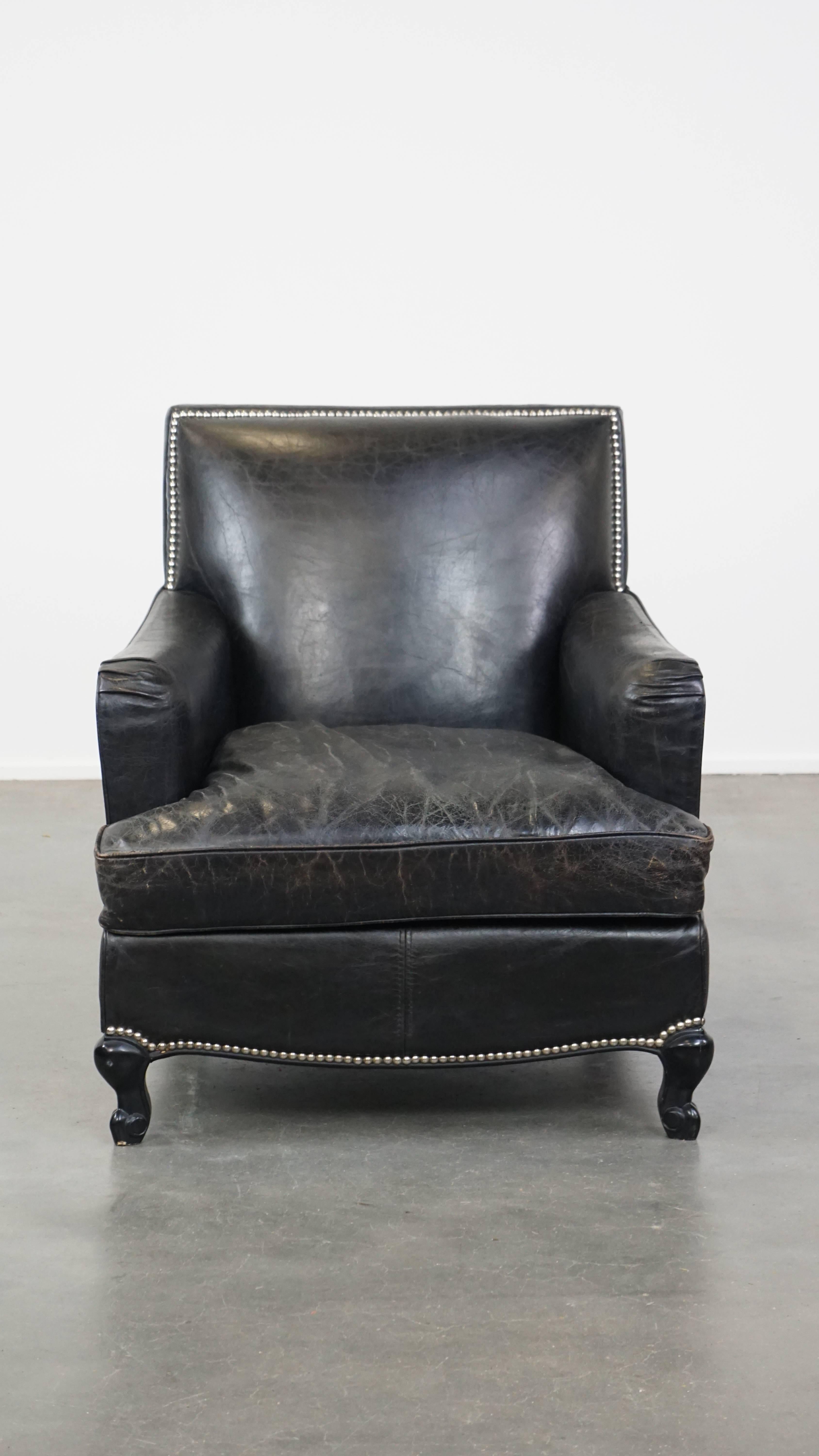 Are you looking for the perfect stylish spot to relax after a long day? Then this cowhideleather armchair is just for you! Its deep black color, decorative nailhead trim, and elegant legs give it a luxurious, refined, and stately appearance.

This