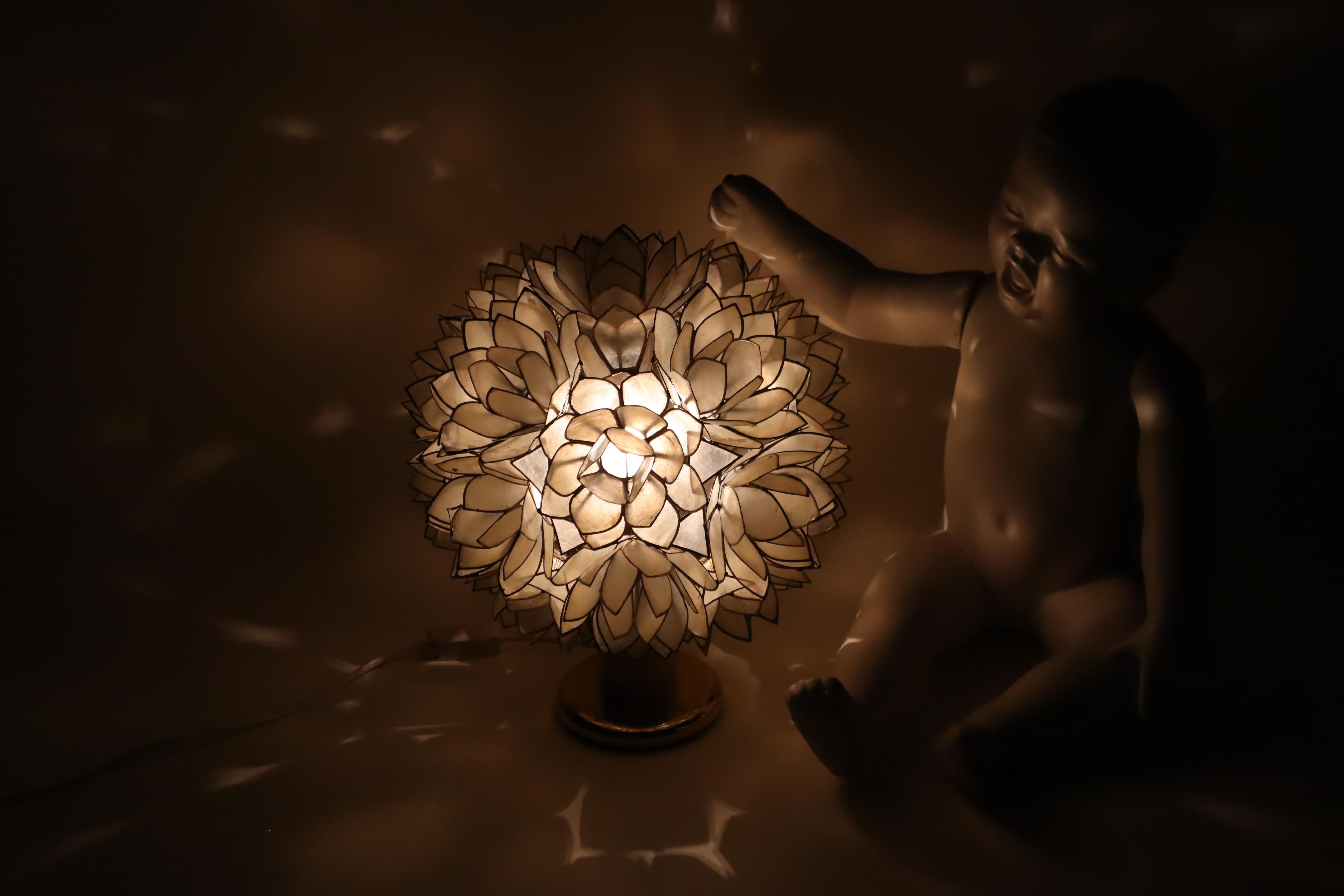 This is one of the most beautiful table lamps ever made. The light from this table lamp is truly unique. The lamp was lovingly handcrafted, with the Capiz shells being carefully cut and then soldered together with lead, similar to the world-famous