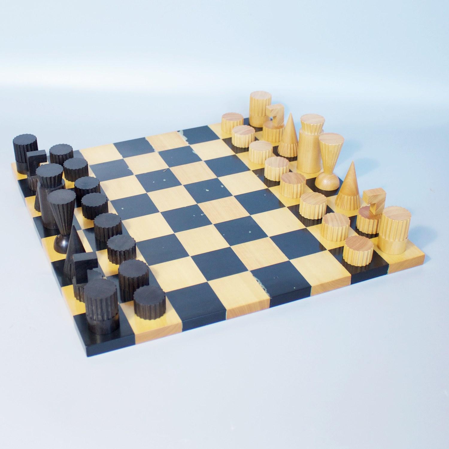 A luxury games set by Ghisó for Dunhill. Hand carved ebony and boxwood chess and draughts pieces in fitted velum cases, with an ebony and boxwood two-sided board. King and Queen of both sides stamped 'Dunhill' to underneath. Ghisó for Dunhill