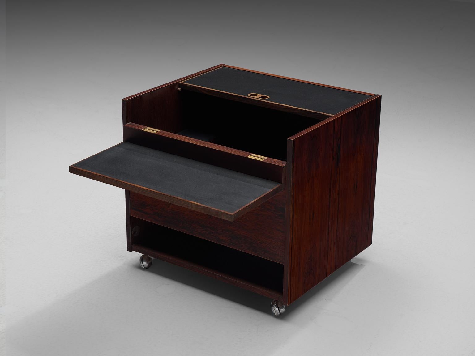 Dry bar, rosewood, Denmark, 1950s.

Luxury cube shaped dry bar in rosewood with interesting use of storage space.
The bar is also provided with a variety of stunning detail, such as the grips.