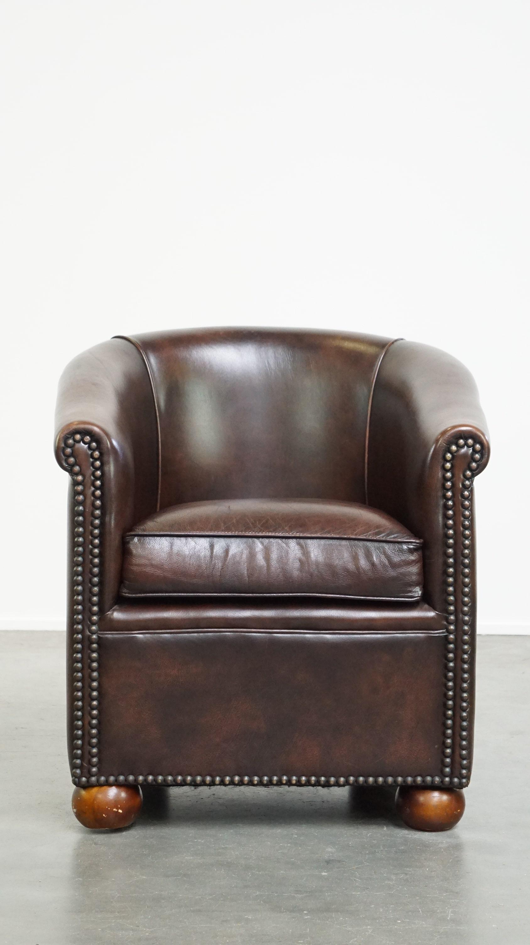 This comfortable leather club chair exudes luxury and elegance through its design, finish, and dark color. It fits easily into both classic and modern interiors. The chair features a removable seat cushion and is finished with large decorative