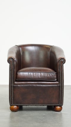 Luxury dark leather club chair with English-style ball feet