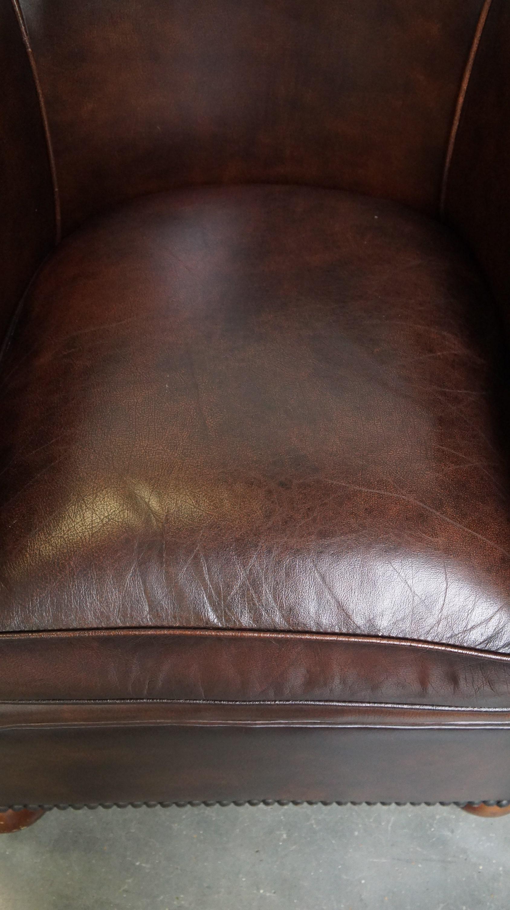 Leather Luxury dark leather club chair with English-style ball feet For Sale