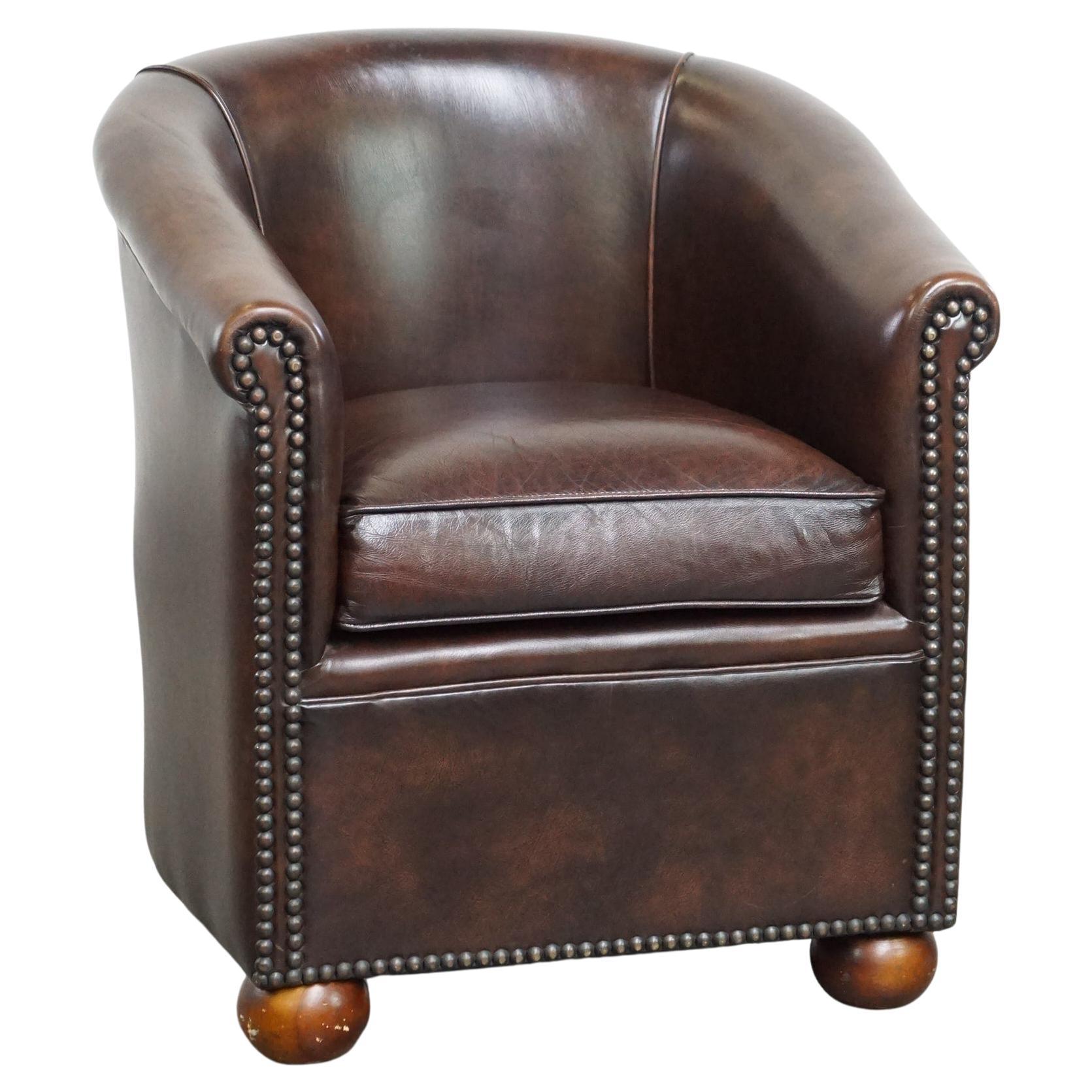 Luxury dark leather club chair with English-style ball feet