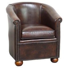 Luxury dark leather club chair with English-style ball feet
