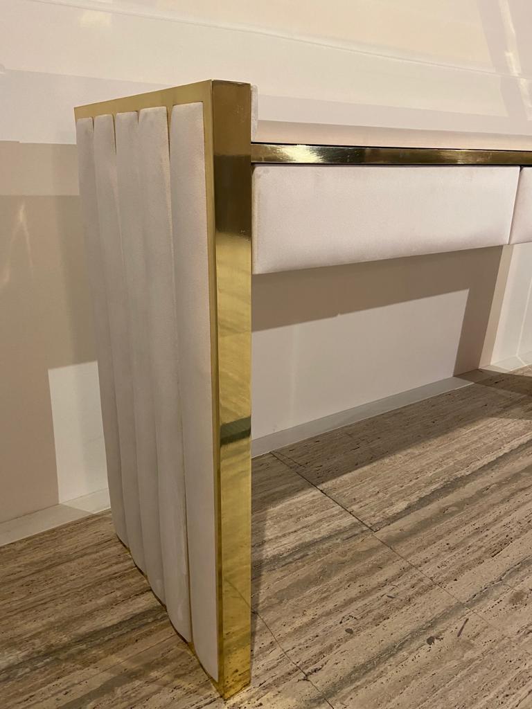 The Luxury gold brass dressing table with drawer offers the ultimate in contemporary style statements. As comfortable in a bedroom as it is. Hand crafted and created for the most discerning of modern interiors. Shown here with soft velvet padded