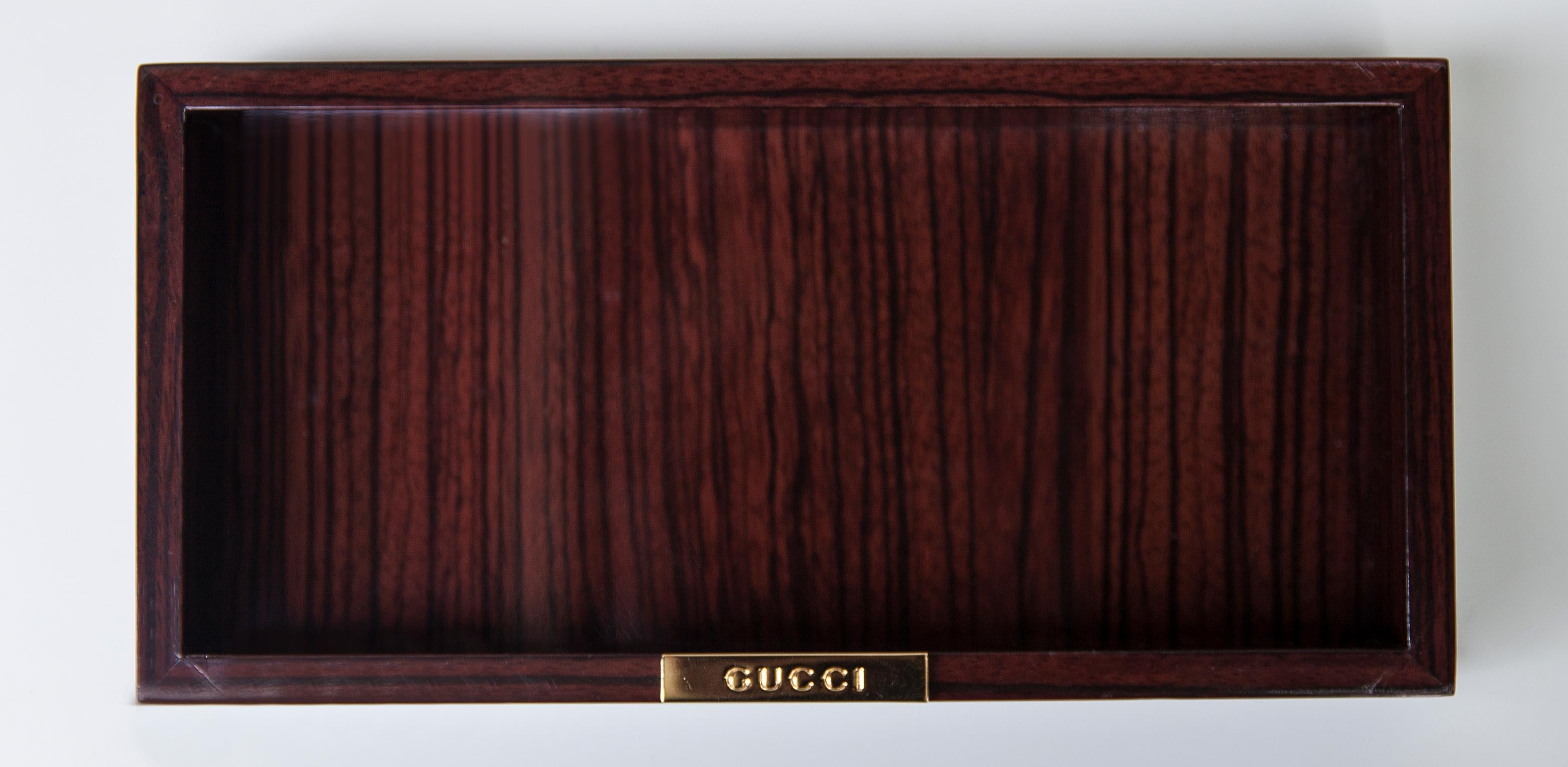 Elegant Gucci bowl in ebony and golden Gucci sign.