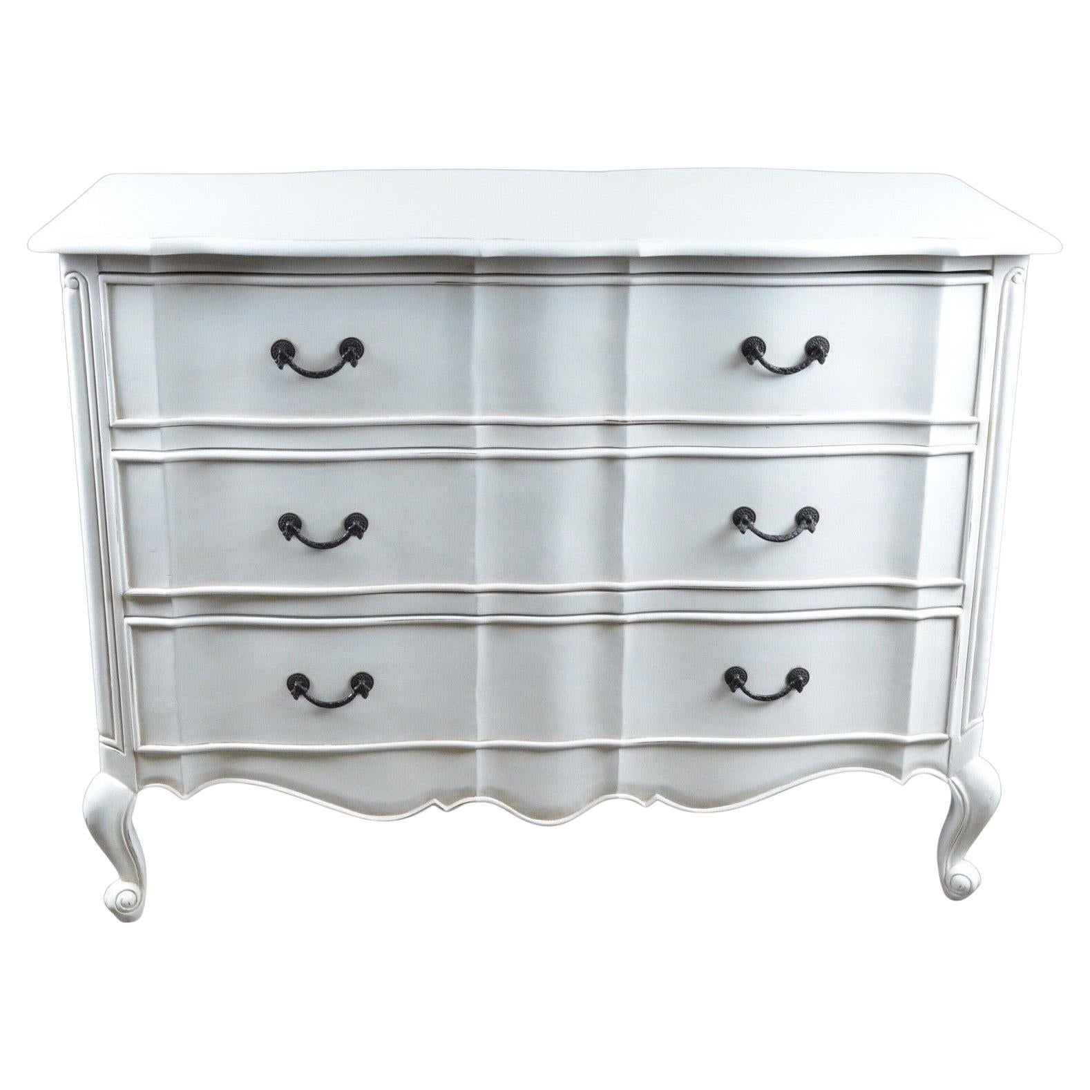 We are delighted to offer for sale this carved mahogany, hand finished in a lightly distressed antique white, this French chest of drawers is serenely elegant and graceful. With rope-style dark metal handles, it is simple yet a chic and elegant