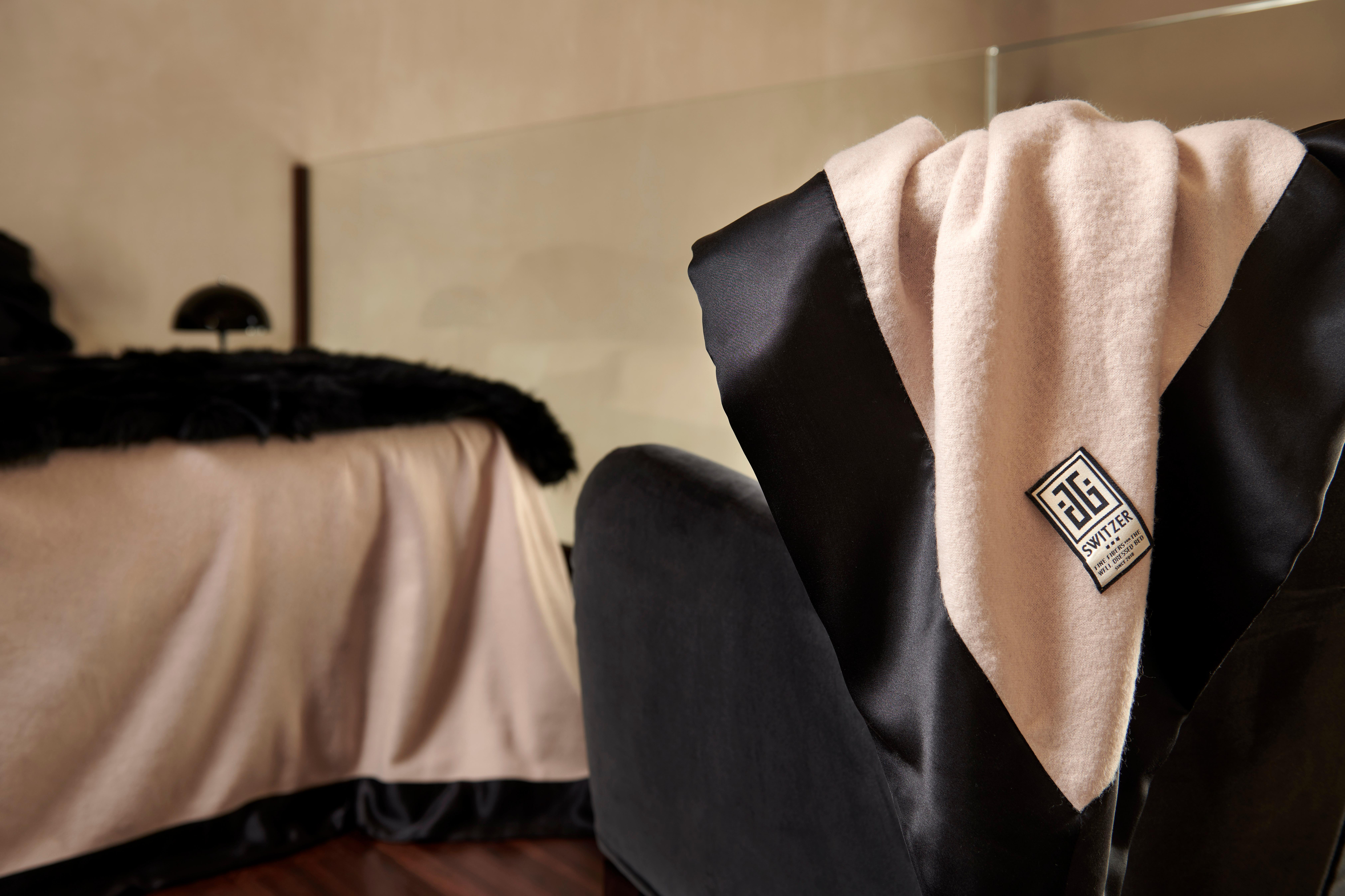 The Camille luxury queen size wool blanket is framed in black as night, 100% pure, 19mm JG Signature 4