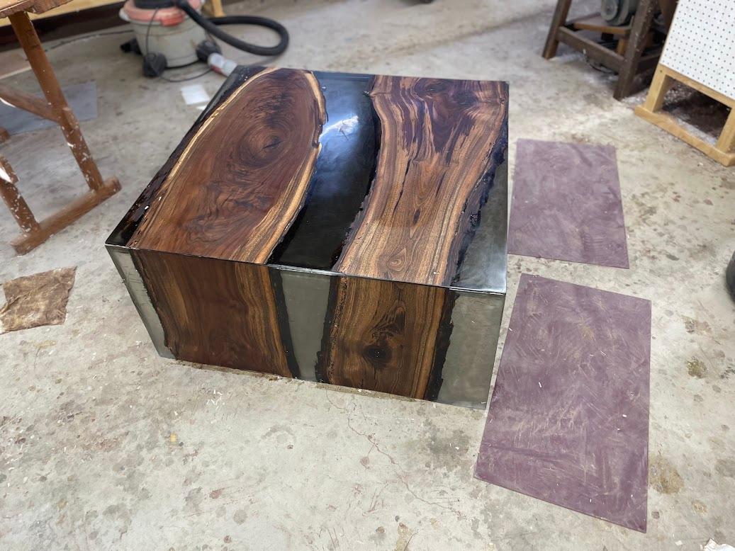 At Jom Rivers Studio, every piece is handcrafted with a deep respect for natural materials and sustainable practices. Measuring 50 inches by 50 inches and standing 18 inches high, this table features a stunning live edge walnut top incased in resin,