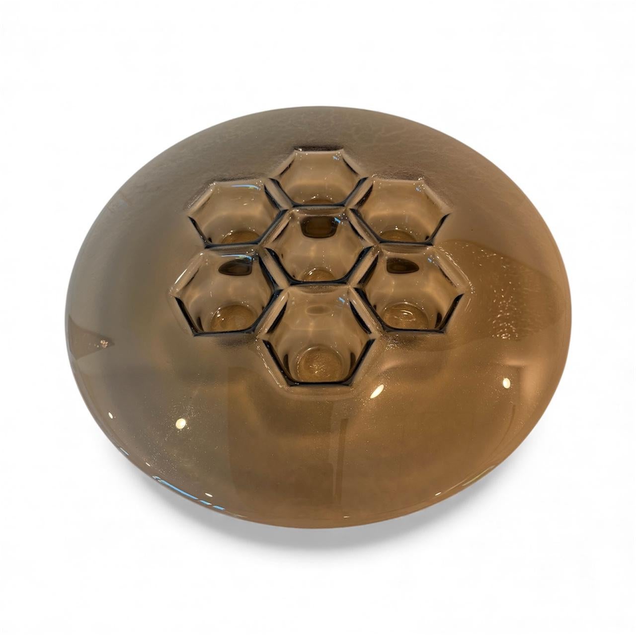 Rich bronze warms the Cells' relief, producing a designer statement bowl that bridges metalwork tradition and glass transparency. PlusObject’s platter carries a brown-copper titanium coat that never oxidises, ensuring the form keeps its mellow glow.