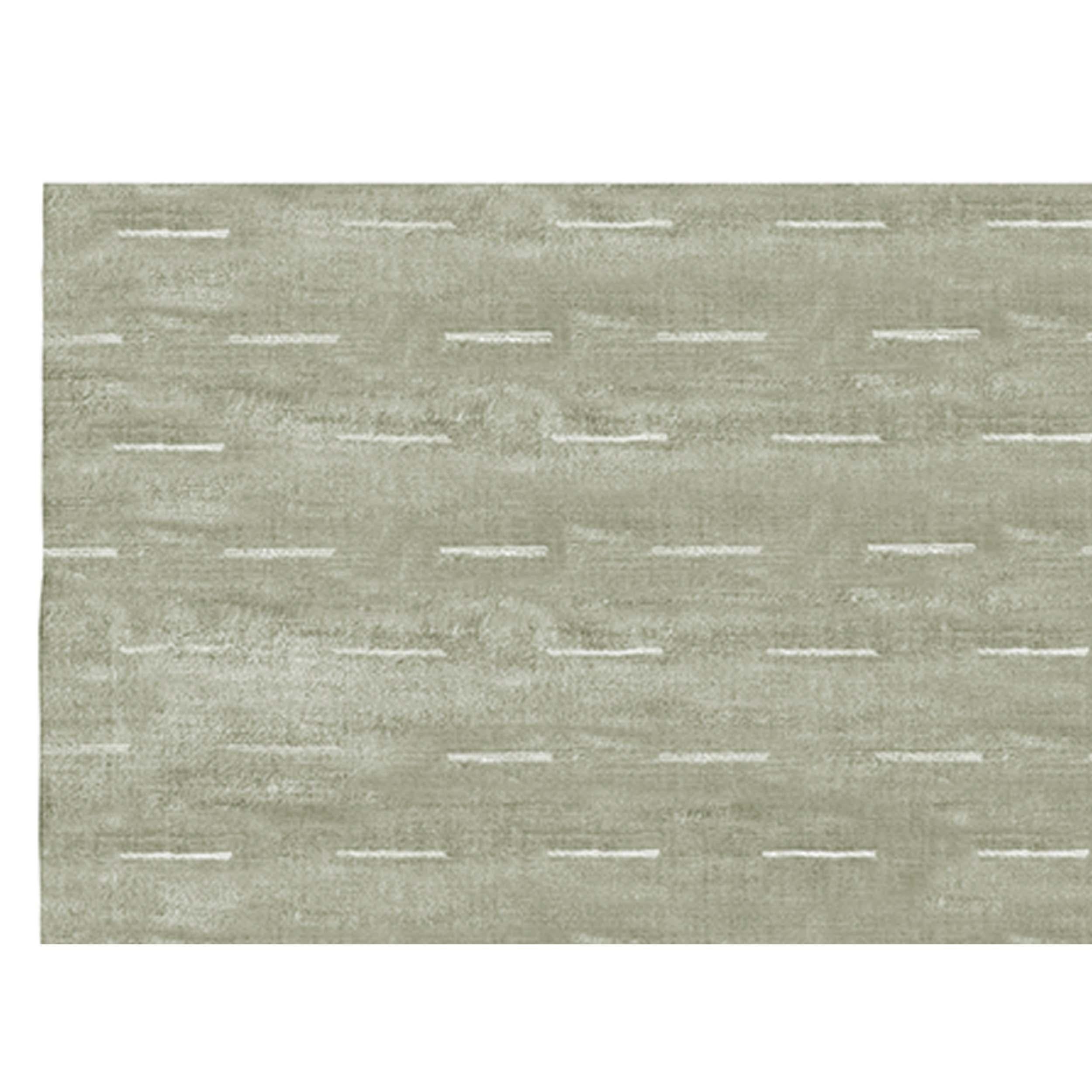 This exquisite modern hand-knotted rug from India offers a delightful sensory experience, captivating both touch and sight with its luscious hand-loomed designs. The use of lustrous viscose creates a surface that is not only incredibly soft to the