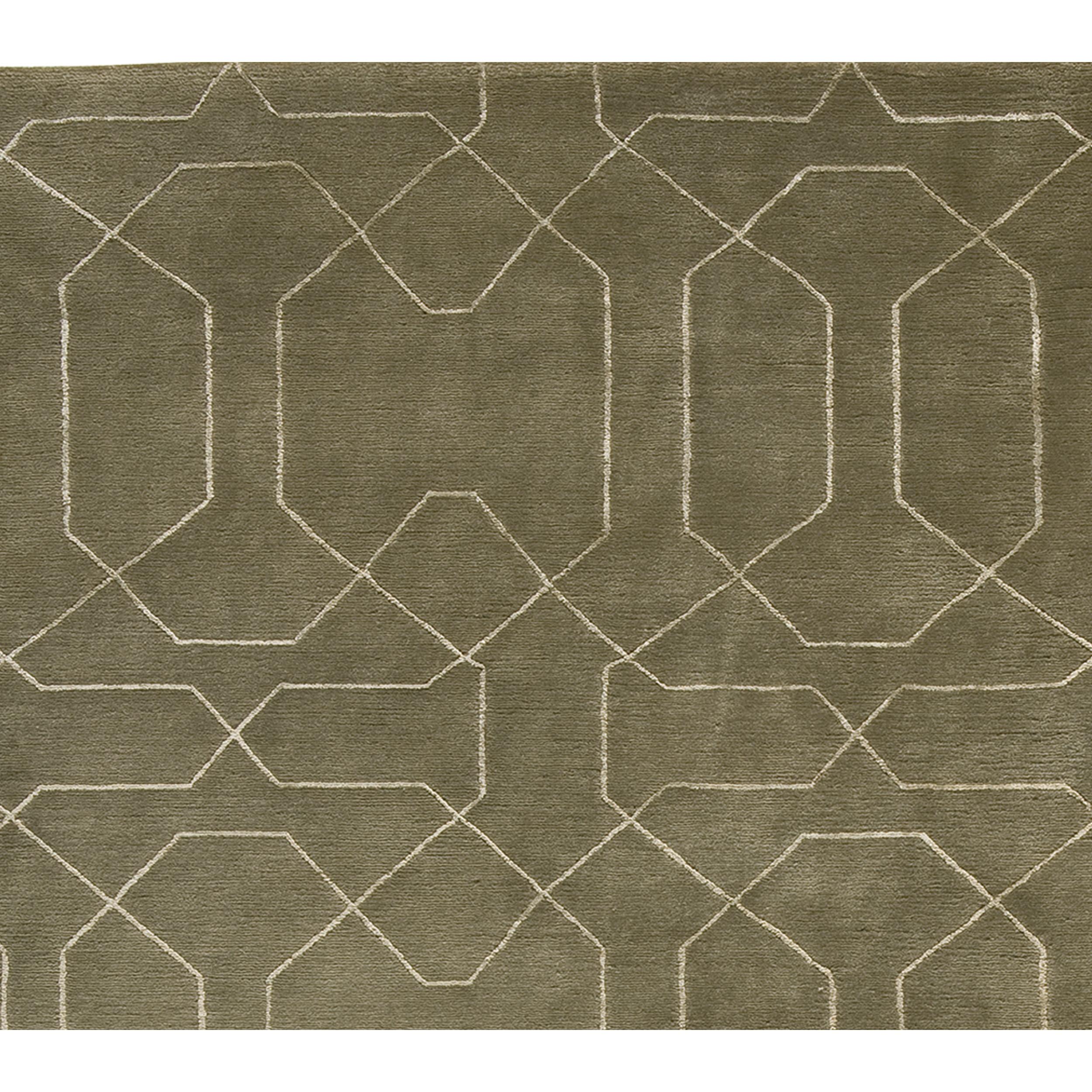 This exquisite modern hand-knotted rug from India offers a delightful sensory experience, captivating both touch and sight with its luscious hand-loomed design. A unique blend of wool and lustrous viscose creates a surface that is not only