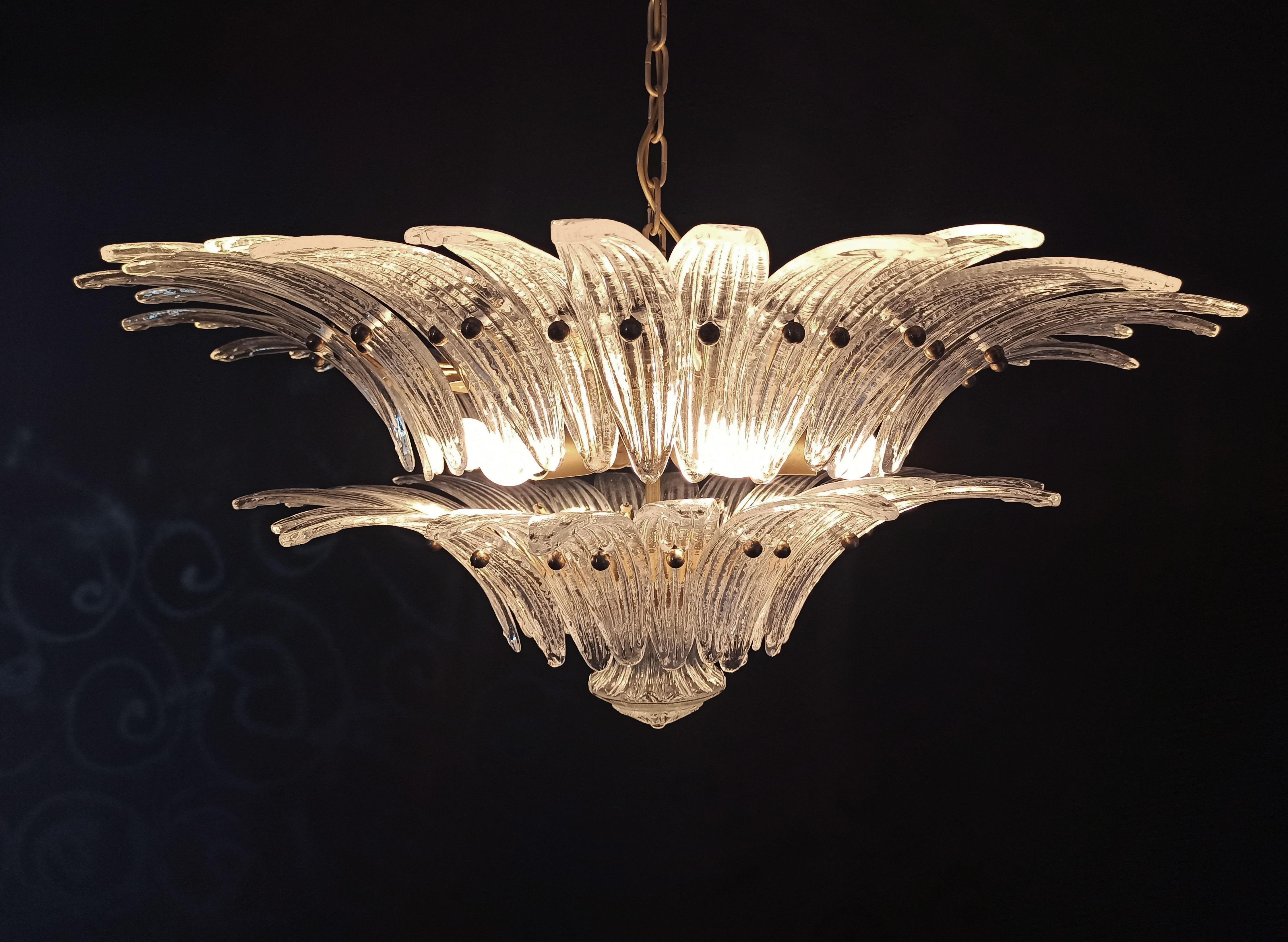 Luxury and genuine Trio Murano glass chandeliere. Handmade in Murano. Each Is made by 58 Murano crystal glasses in a gold metal frame. The chandelier has also a Murano glass ball in the end of the lamp. Murano blown glass in a traditional