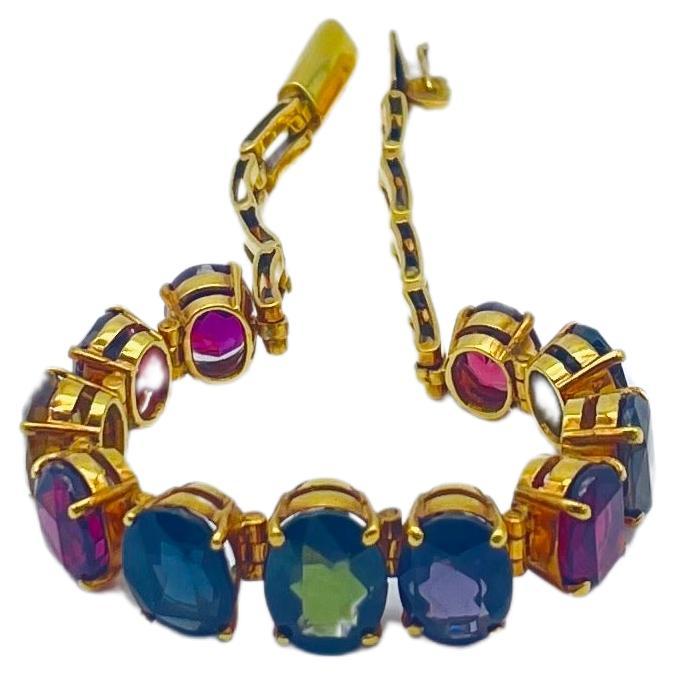 Indulge in the dreamlike allure of this stunning bracelet, crafted with meticulous detail in 14k yellow gold. This captivating piece features 11 exquisite gemstones, including rubies, sapphires, citrines, tourmalines, and amethysts, each masterfully