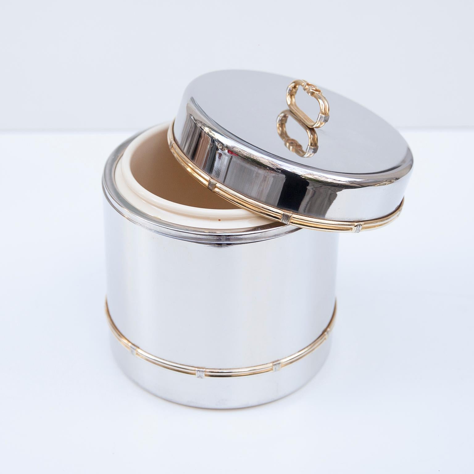 Luxury vintage Gucci ice bucket in chrome and brass with and plastic inlay and marked with the golden Gucci sign from the 1970s and on the bottom.