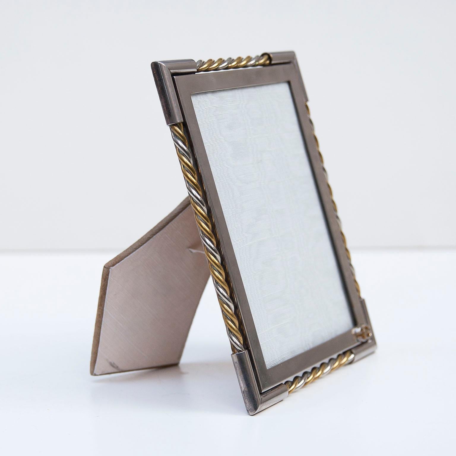 Luxury vintage Gucci picture frame in chrome an brass with the golden Gucci sign.